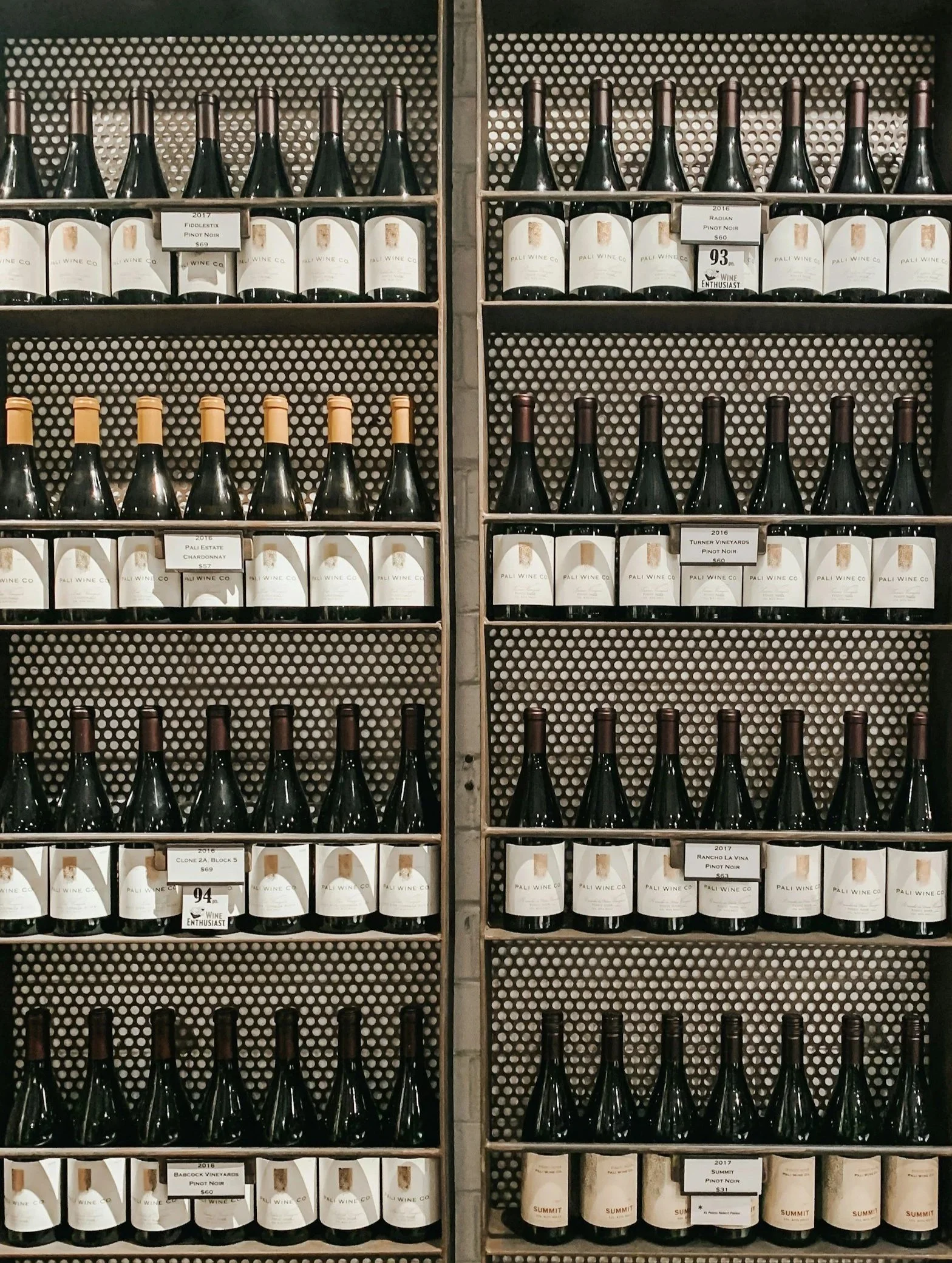 Shelves of wine bottles with labels from Pali Wine Co displayed in a store.