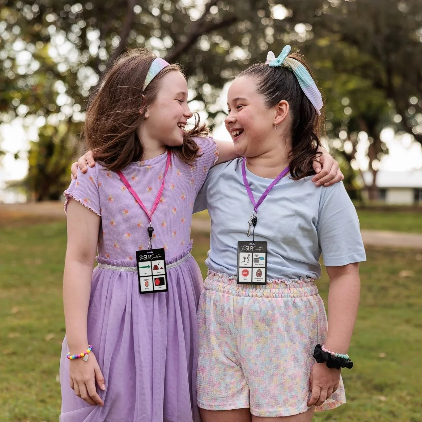 Two young girls wearing communciation lanyards