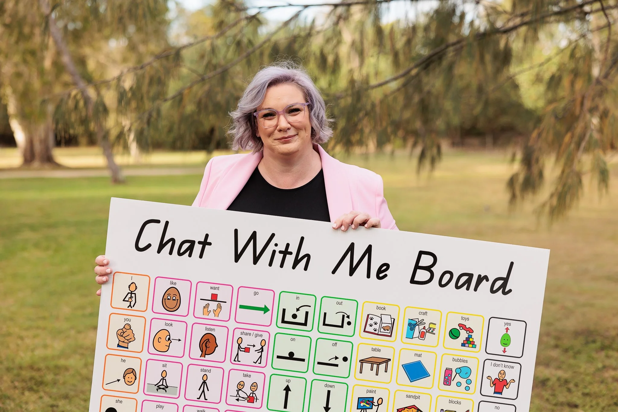 Haley the SLP Creative holding one of her Chat With Me Boards