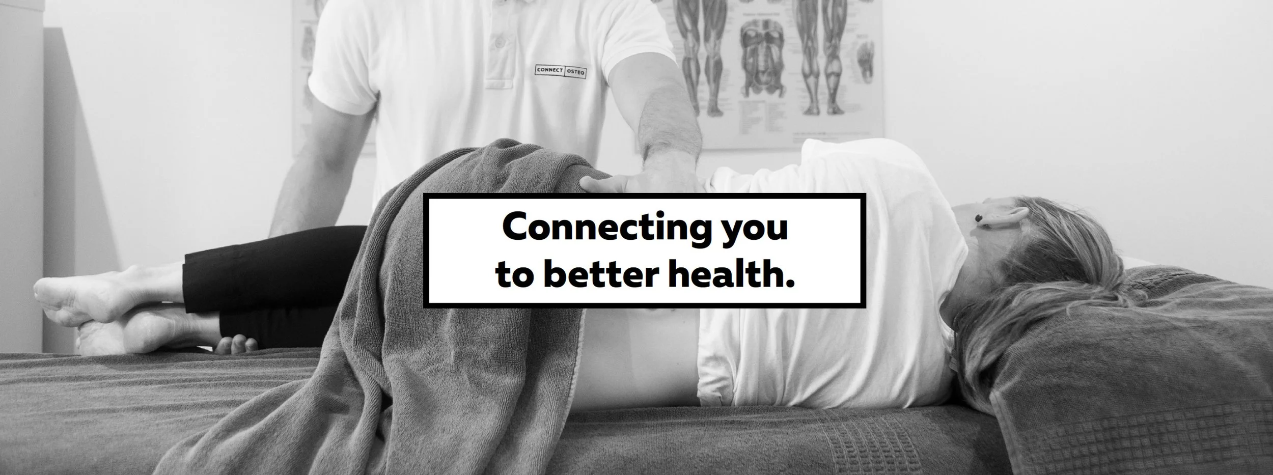 A healthcare professional performing a physical therapy or chiropractic adjustment on a woman lying face down on a treatment table, with a poster of human anatomy in the background. Overlaid text reads, "Connecting you to better health."