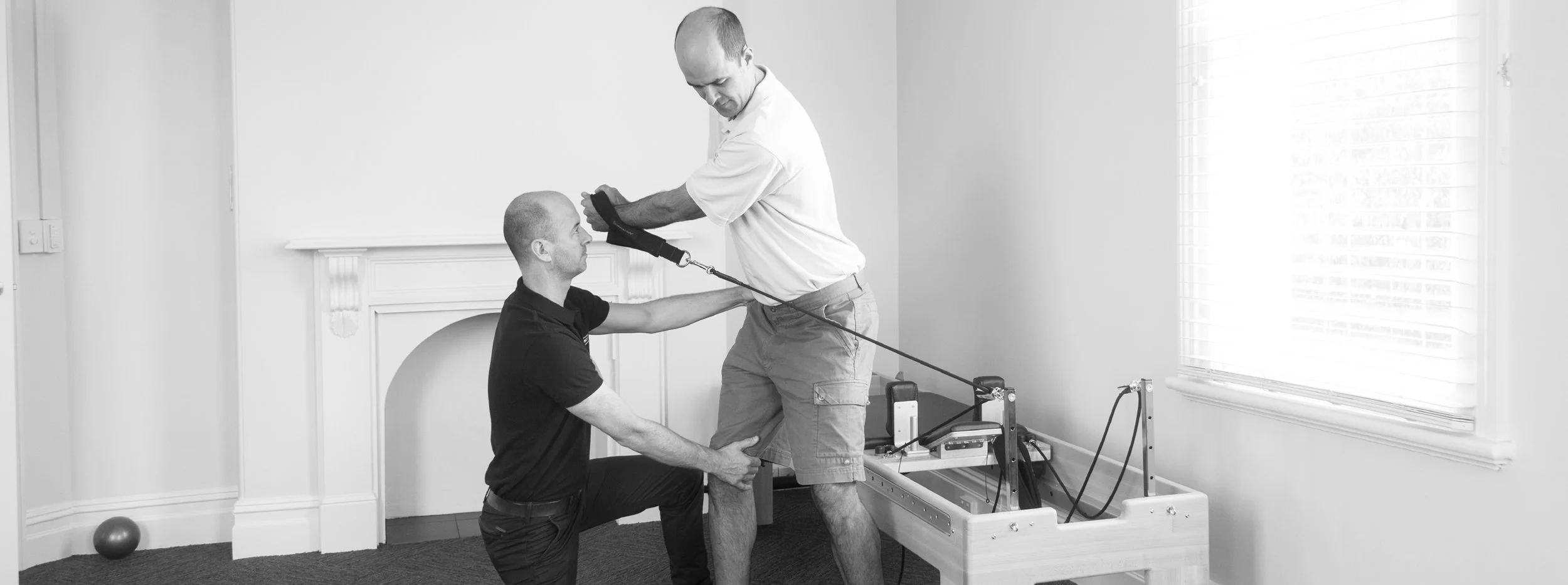 Physical therapist assisting patient with gait training on a treadmill.