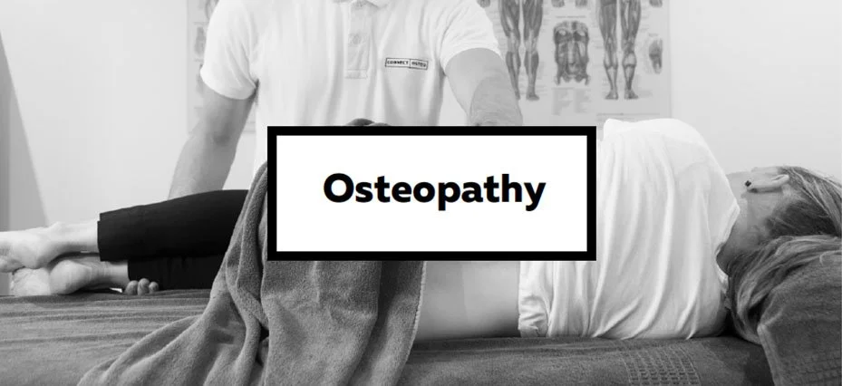 A person lying face down on a treatment table with an osteopath standing beside them, in a clinic with anatomical posters on the wall. The word 'Osteopathy' is overlaid on the image.