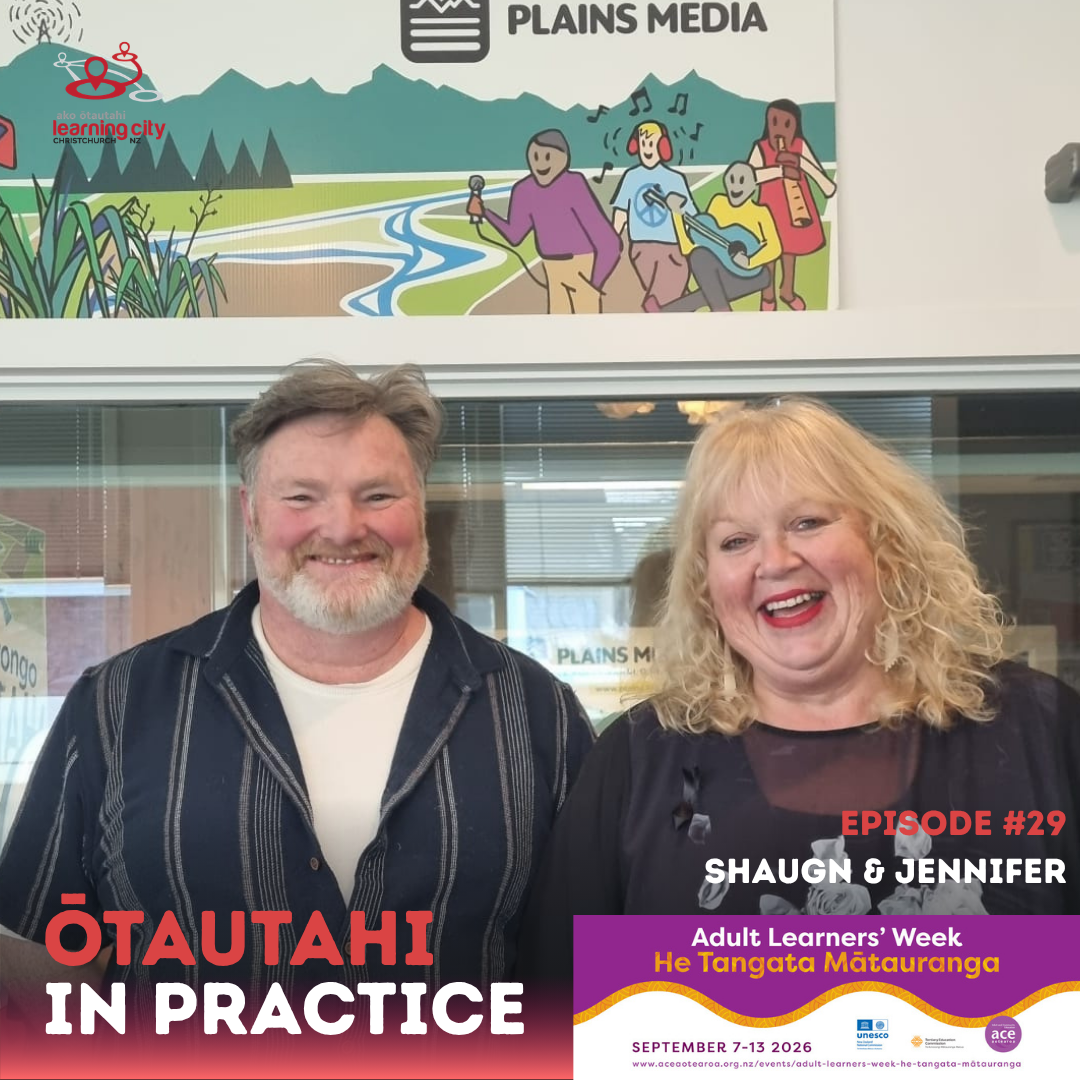 Jennifer & Shaugn standing in front of a recording booth at PlainsMedia and smiling.