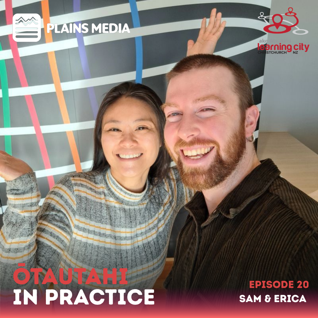 Sam & Erica smile at the camera with Rātā in the background.