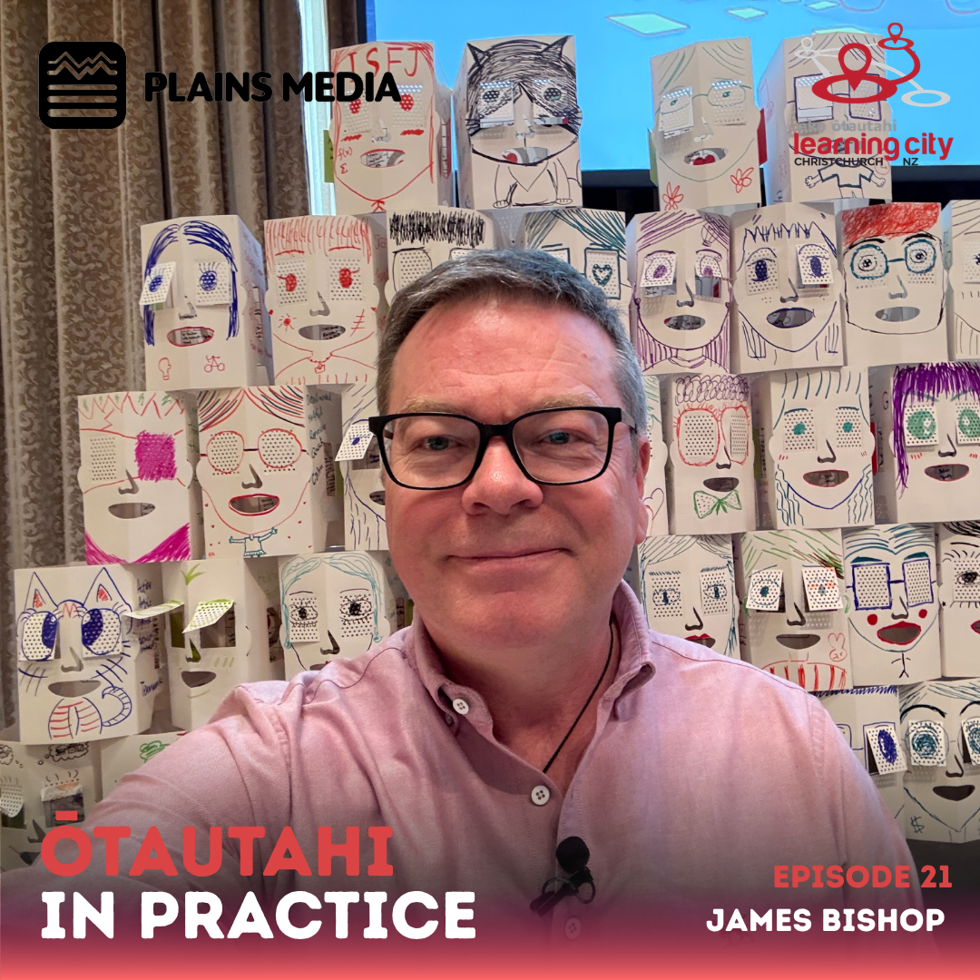 James faces the camera with a lot of masks in the background.