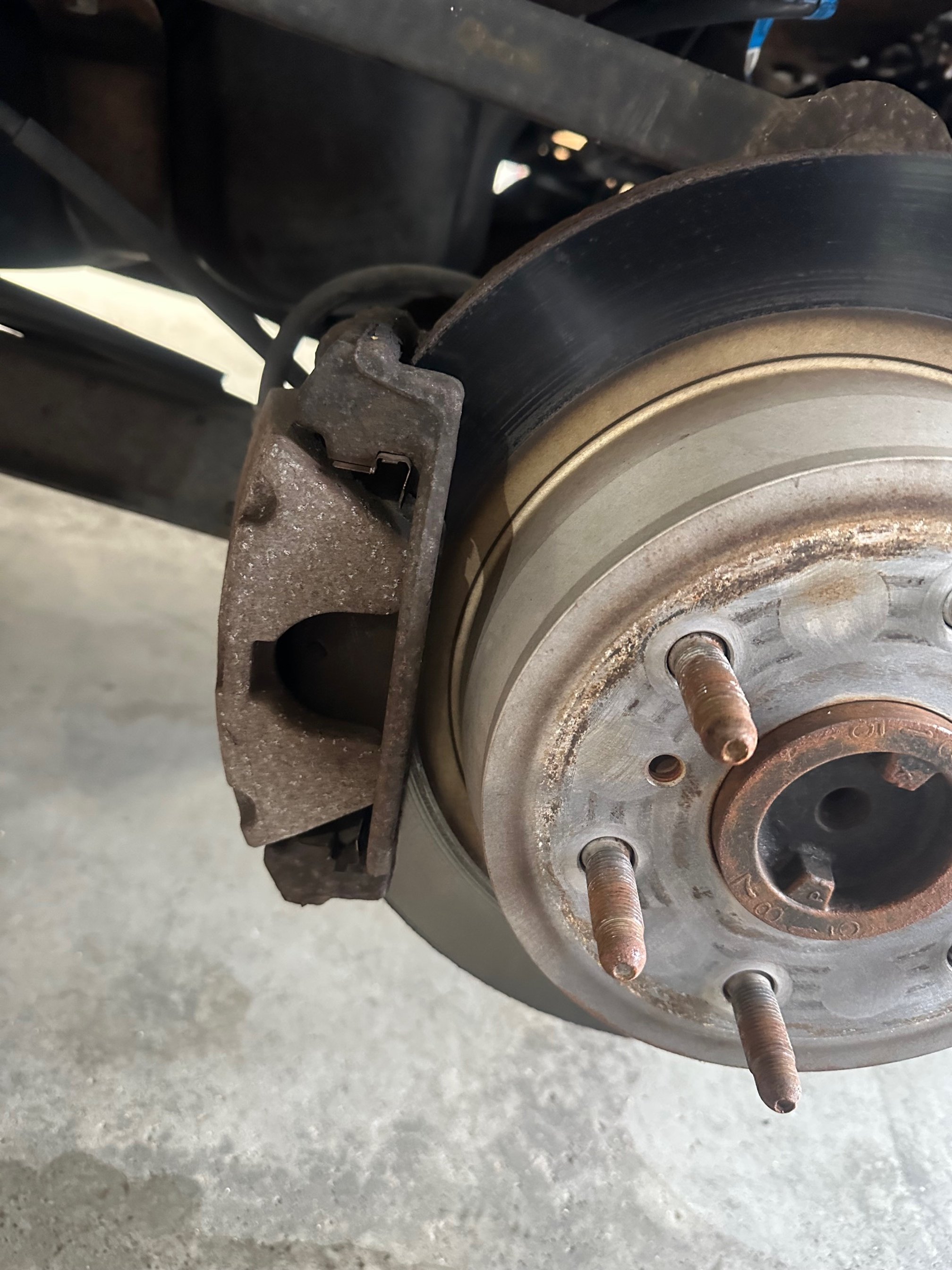 Replaced Brake Pads & Rotors On Both Rear Sides (Before Image)