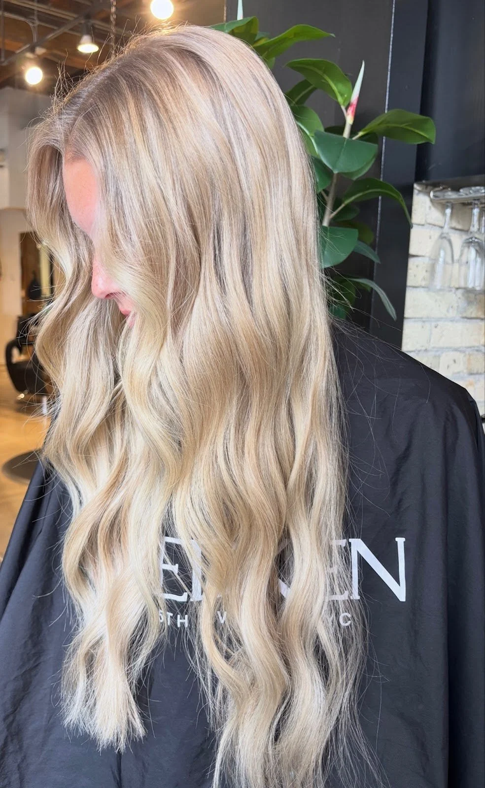 Studio M Aesthetics client with soft, sun-kissed dimensional blonde balayage.