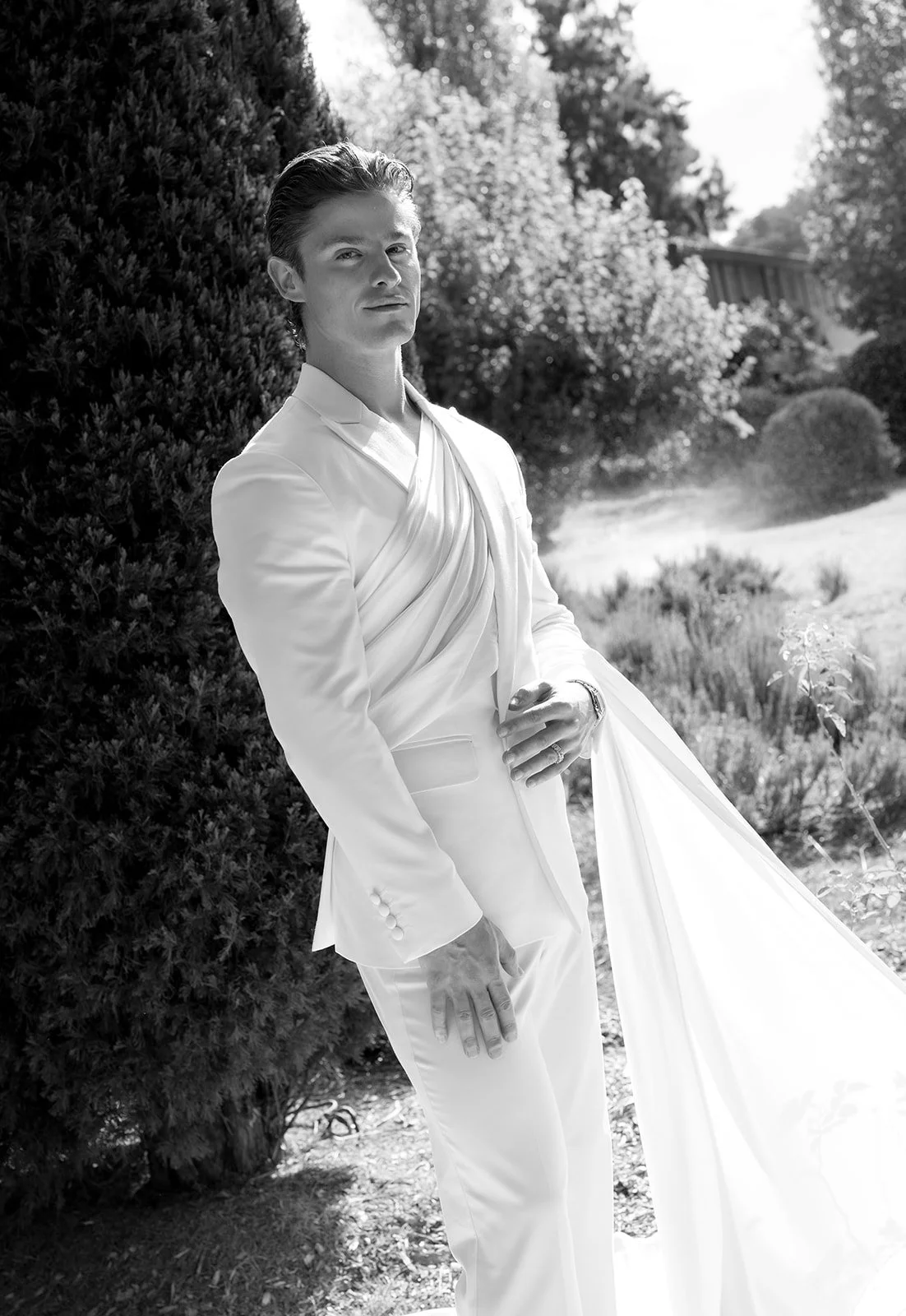 groom-wrap-suit-garden-portrait.jpg