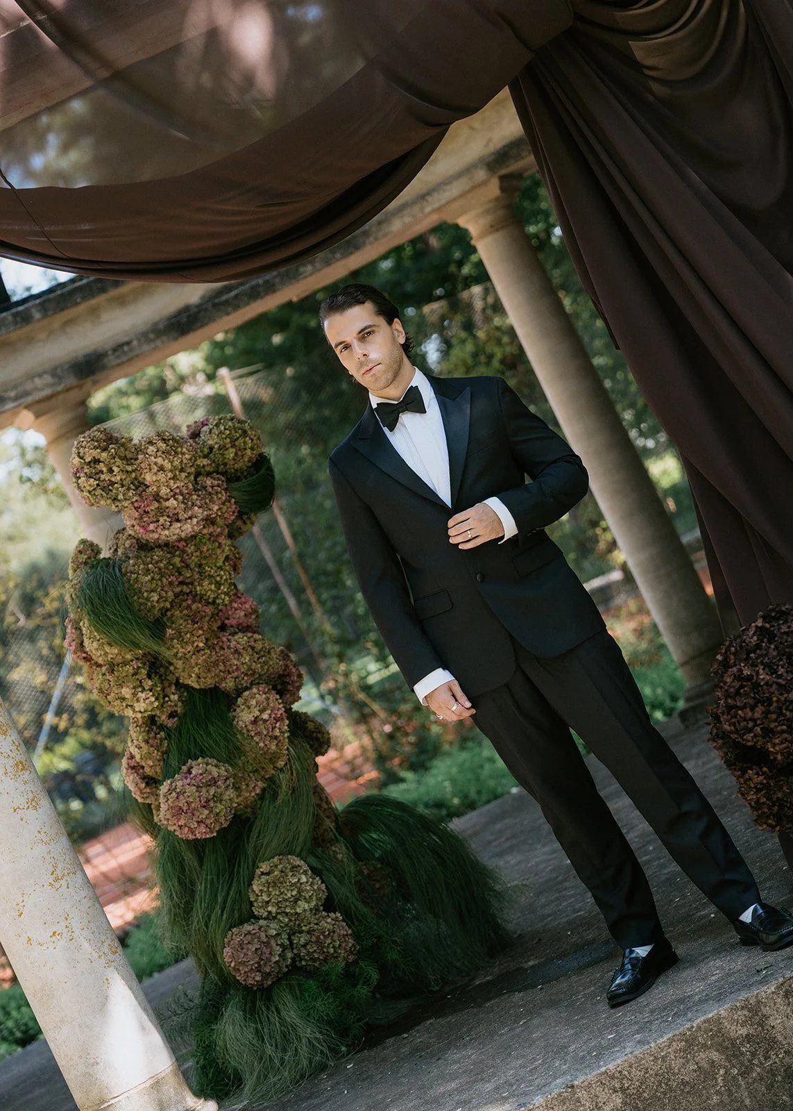 groom-portrait-floral-column-canopy.jpg