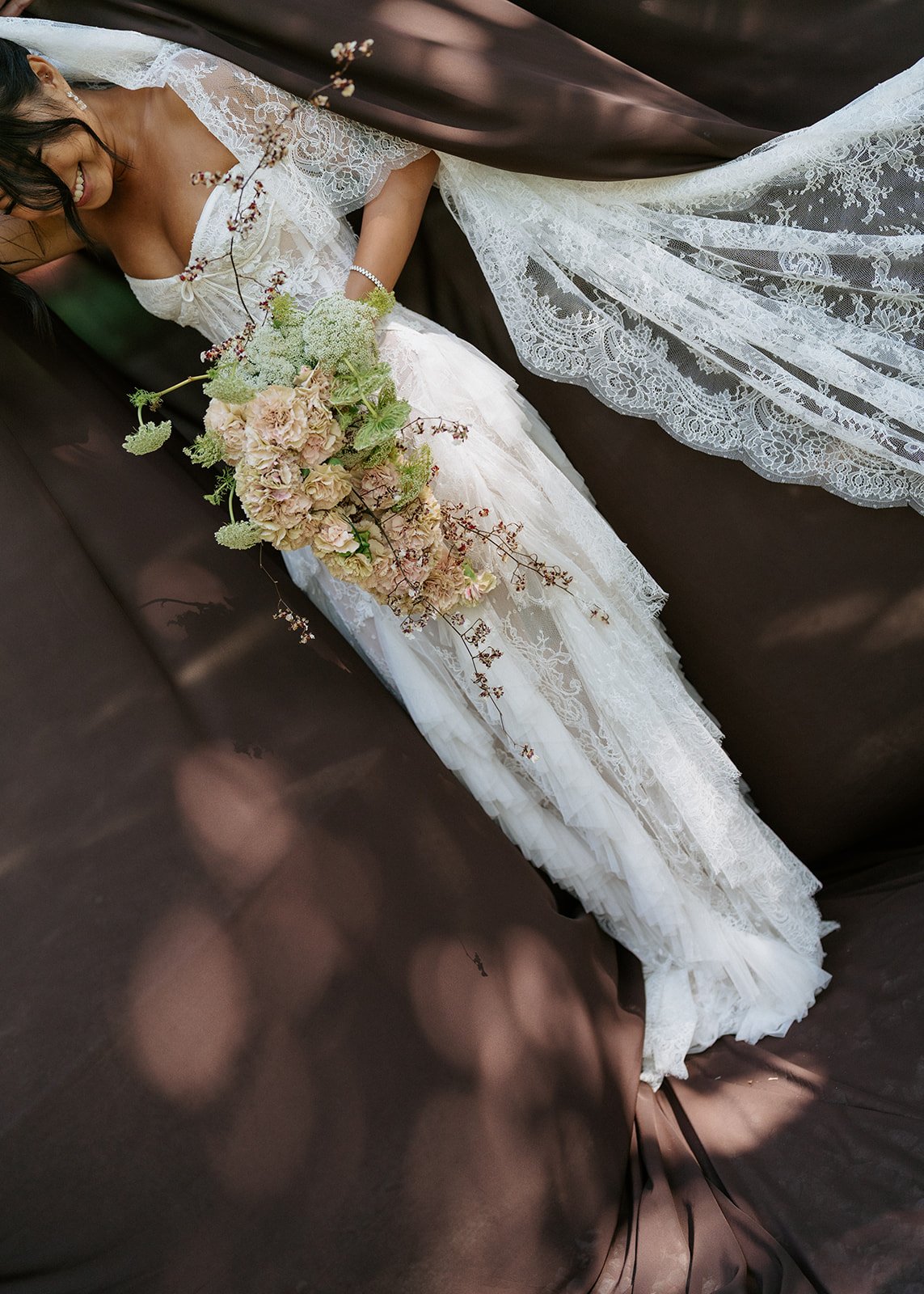 bride-laughing-lace-gown-bouquet.jpg