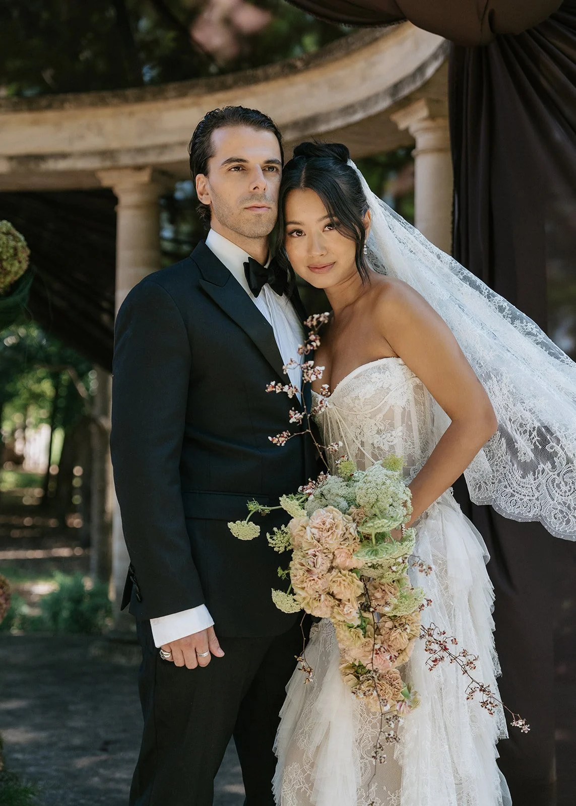 bride-groom-embrace-portrait-veil.jpg