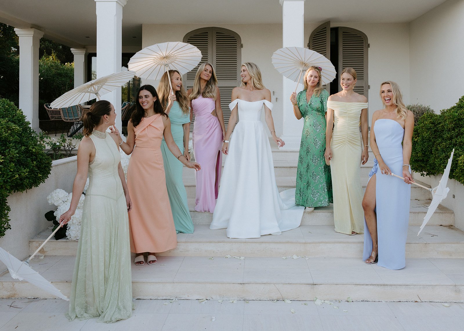 bridal-party-pastel-dresses-parasols.jpg