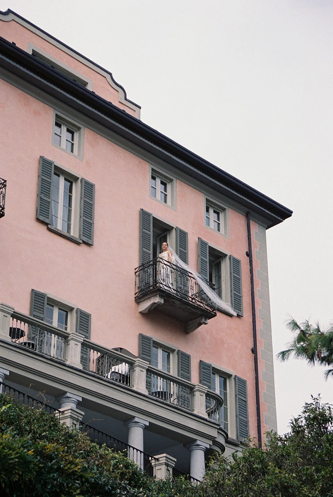 bride-balcony-pink-villa-film-photography.jpg