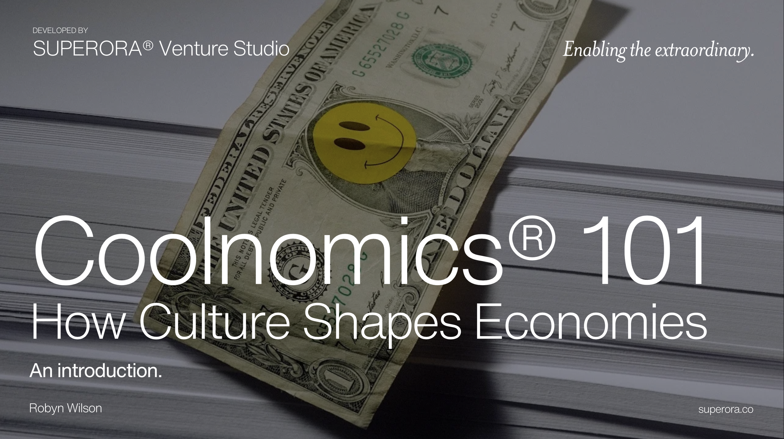 Book cover titled "Coolnomics 101: How Culture Shapes Economies" by Robyn Wilson, developed by Superora® Strategy Studio, featuring a stack of paper and a US dollar bill with a smiley sticker over George Washington's face.