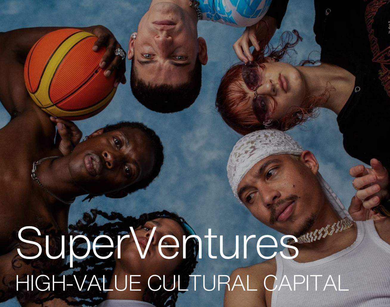 Group of diverse individuals in a circle looking down at the camera, one holding a basketball, with "SuperVentures High-Value Cultural Capital" text overlay on a blue background.