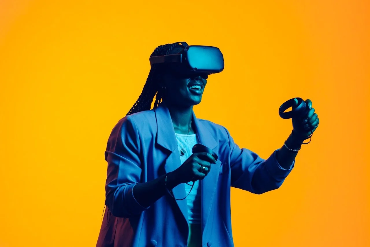 Person wearing a VR headset and holding controllers against an orange background.