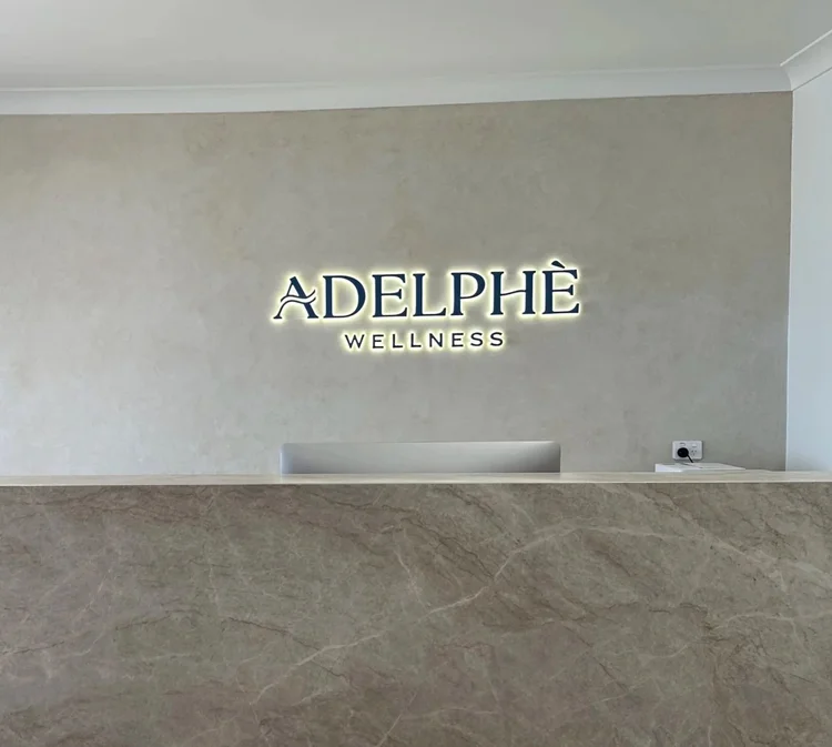 Adelphè Wellness halo-lit sign