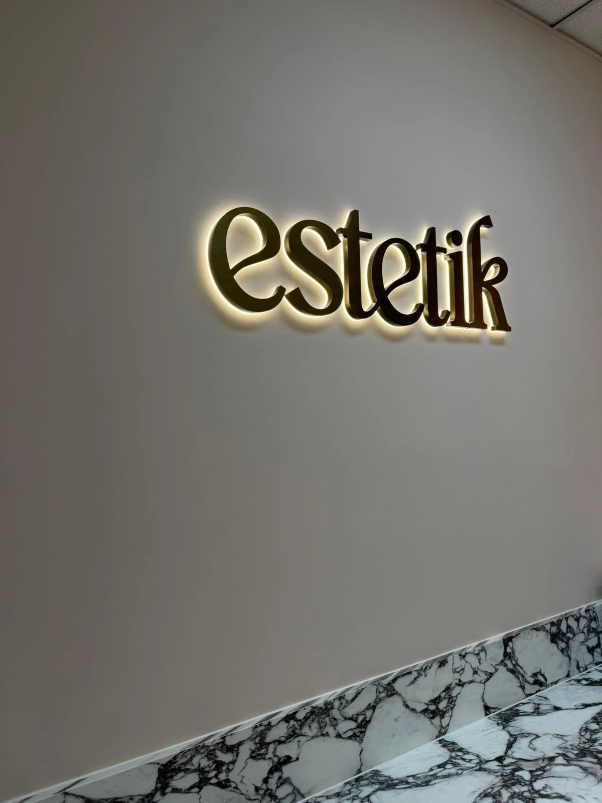 Estetik warm-tone backlit LED sign - custom halo-lit lettering for beauty business Adelaide