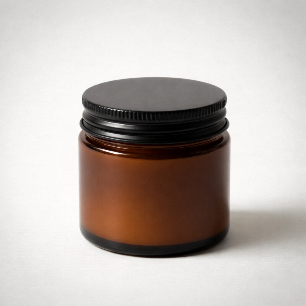 Brown glass jar with a black screw-on lid on a plain white background.