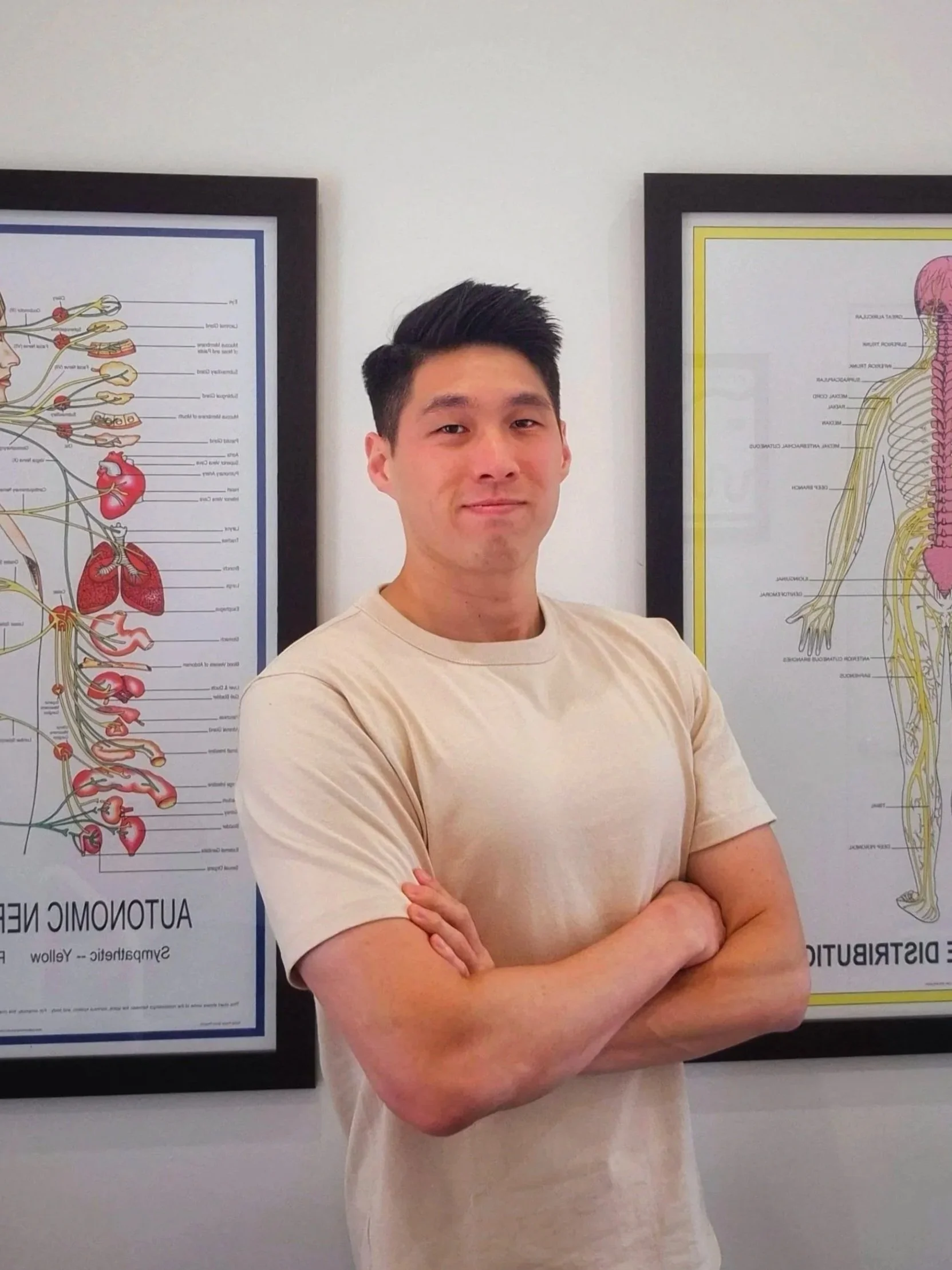 A smiling woman with glasses, hoop earrings, short curly hair, wearing layered necklaces and a striped blouse.