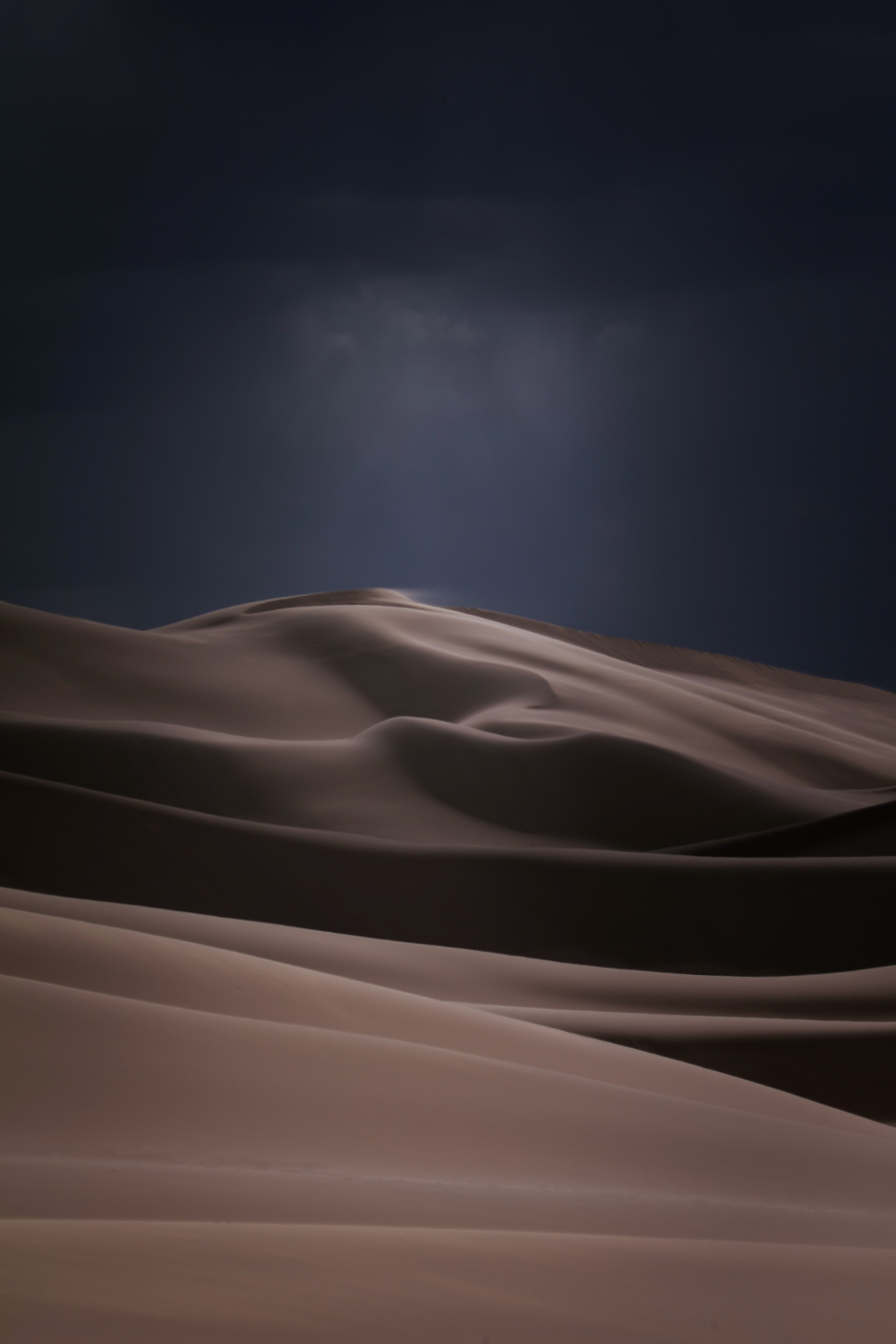 Dark stormy sky over sand dunes in a desert