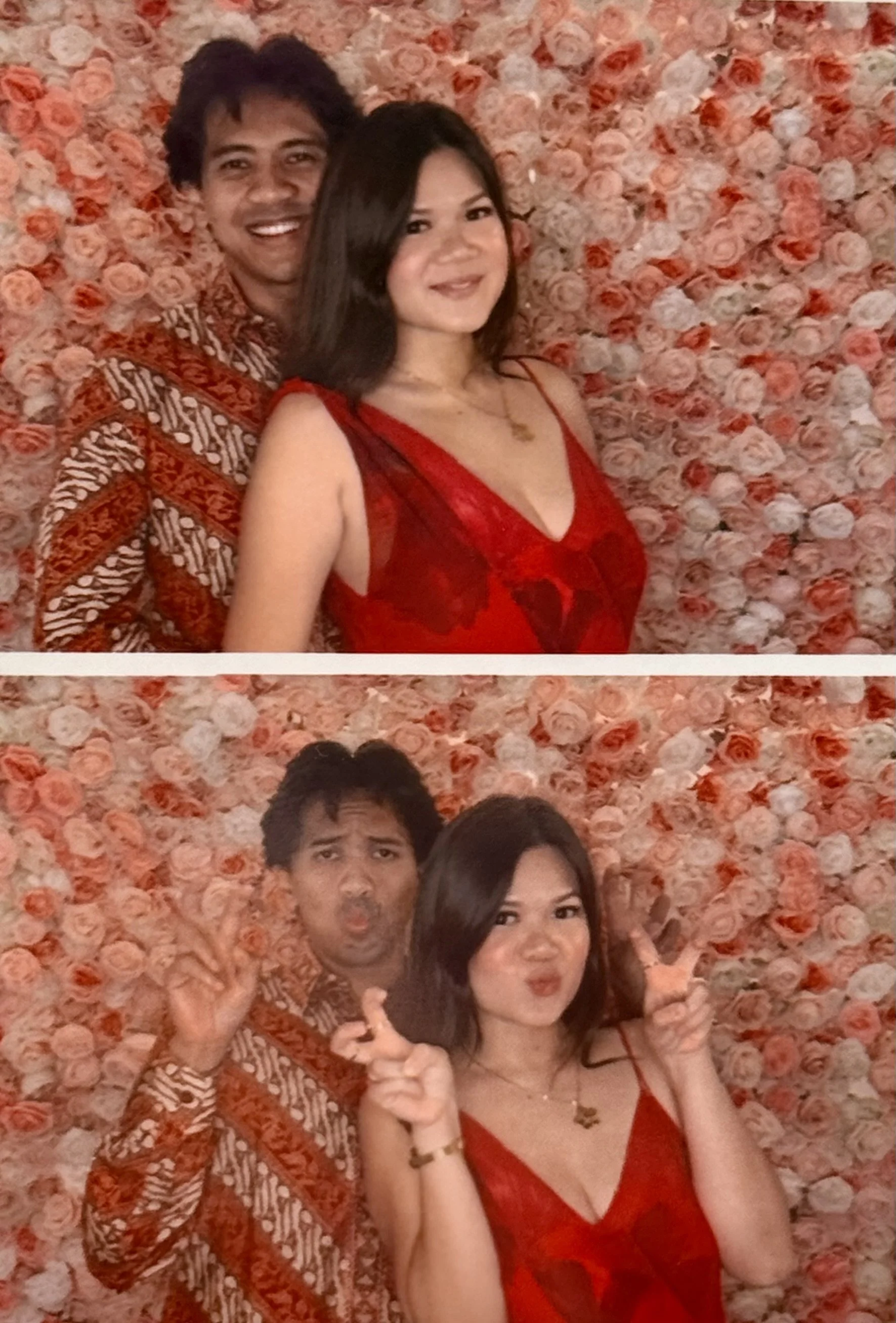 A couple taking fun photos in front of a pink and peach rose wall. In the first photo, they are smiling; in the second, they are making playful faces and peace signs.