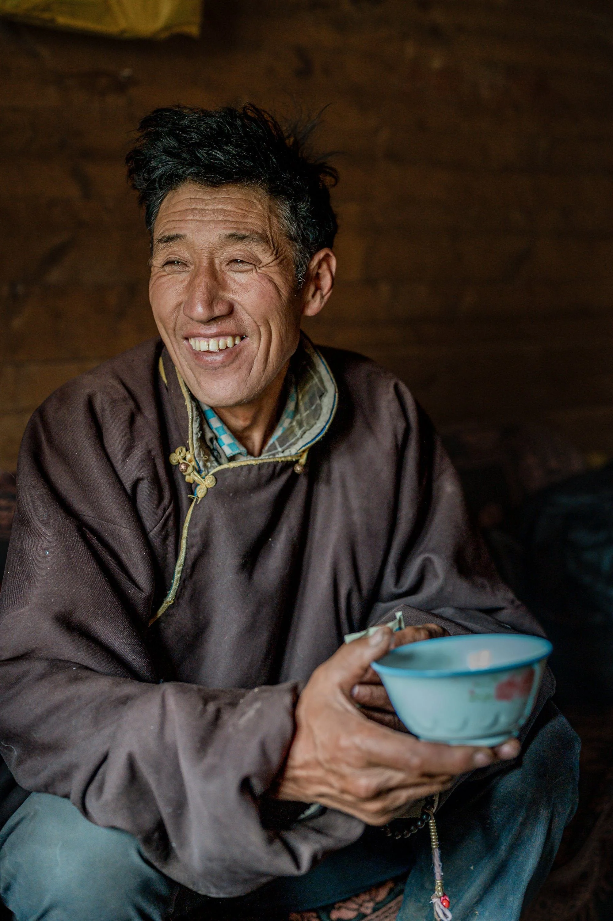tibetan-nomad-man-tea-bowl-laughing-village-eleanor-moseman.jpg