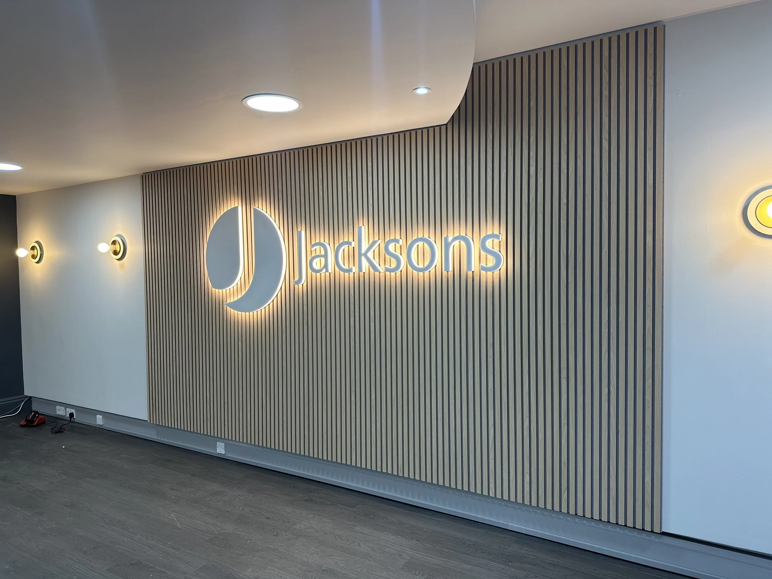 acoustic panelled wall with illuminated led stand off letter for Jacksons estate agents