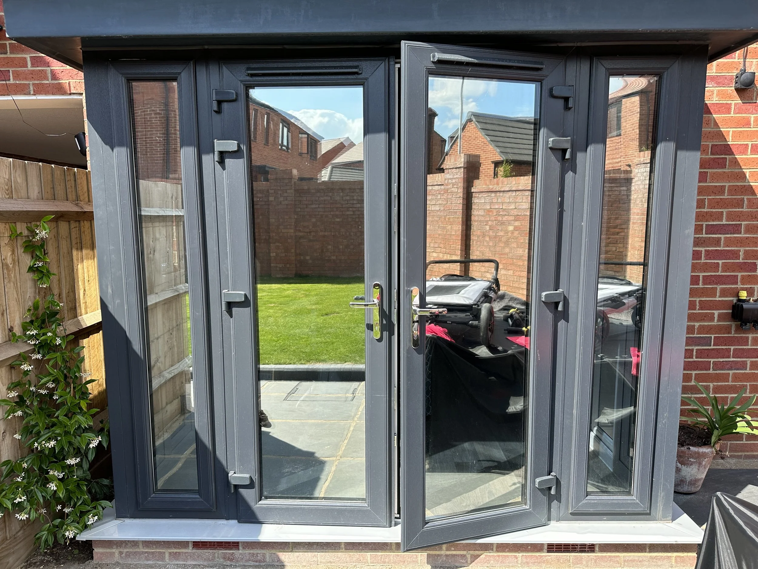 residential rear doors tinted in reflective window film for privacy and heat reduction.