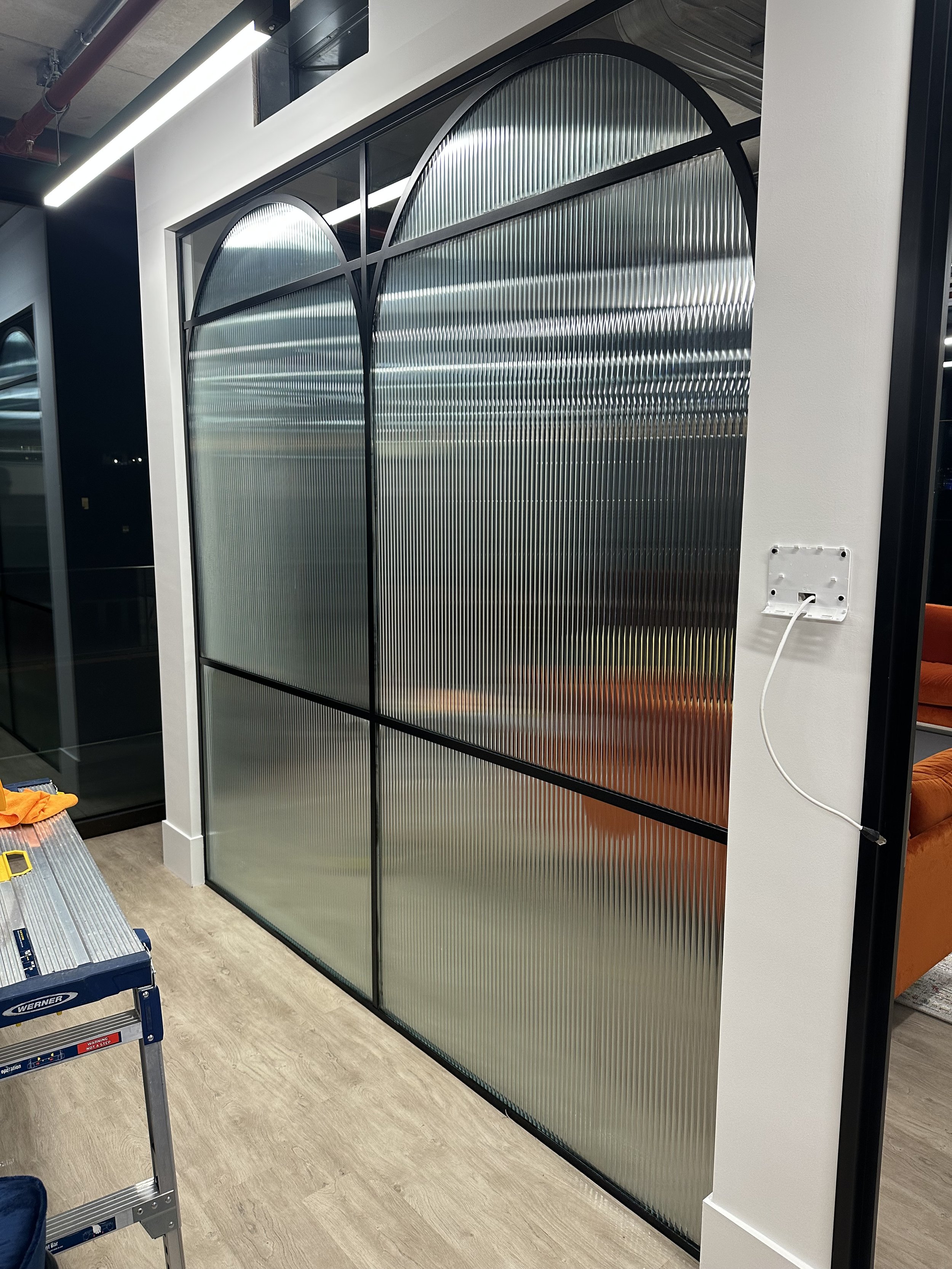 metal arched crital with reeded glass film installed.