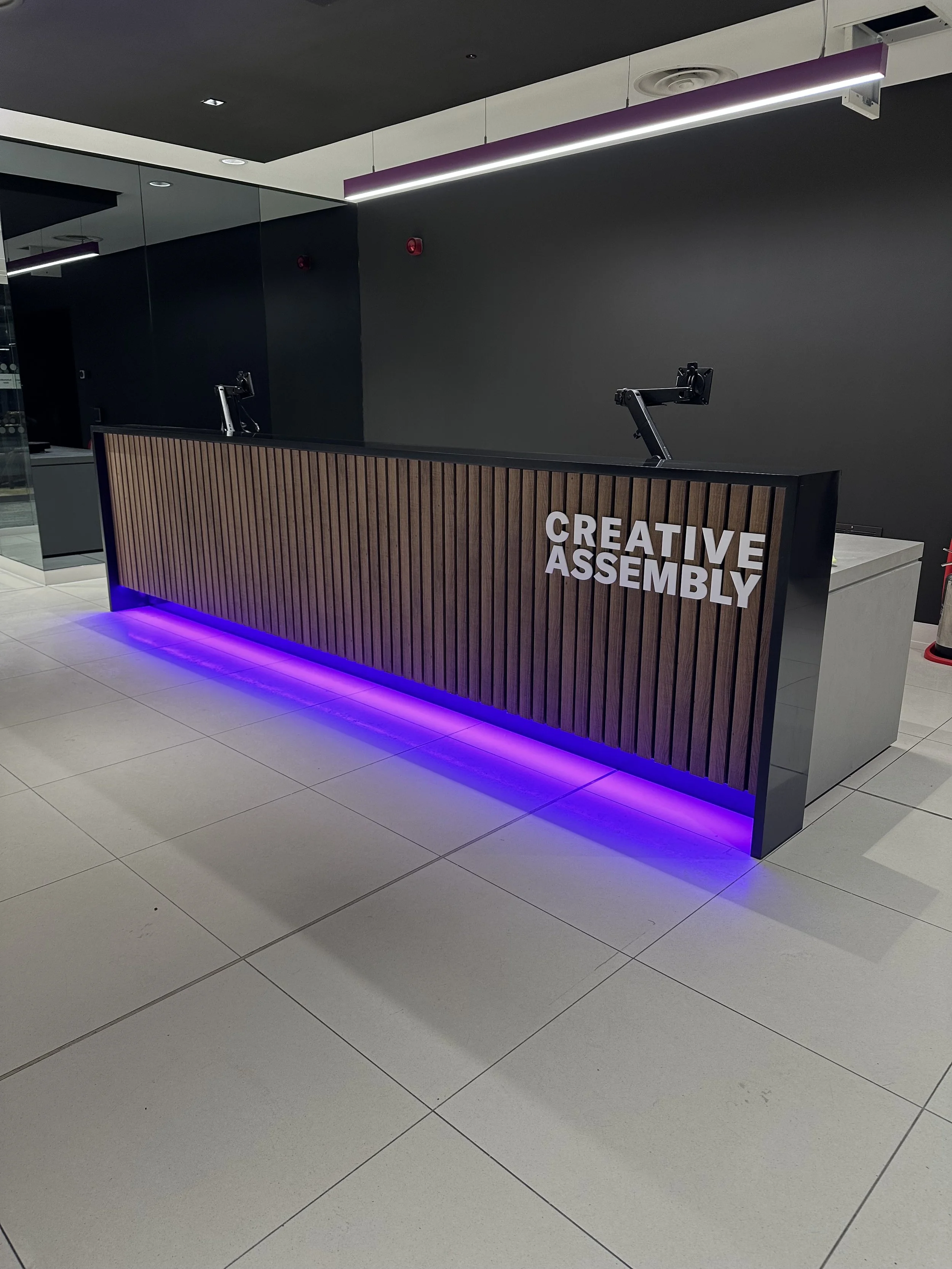 acrylic lettering installed to the front desk at creative assembly.