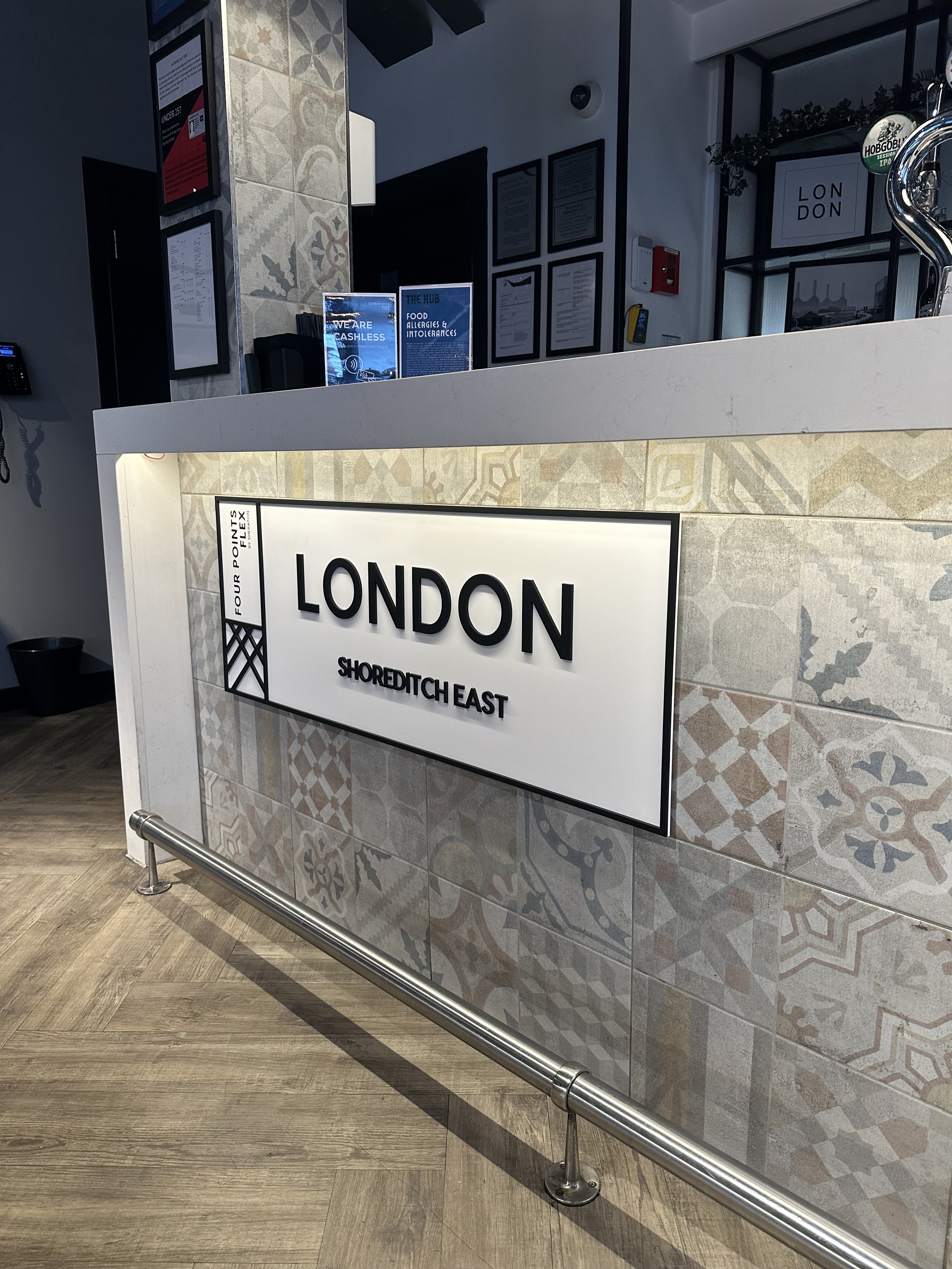 foamex panel fixed to a reception desk at a hotel.
