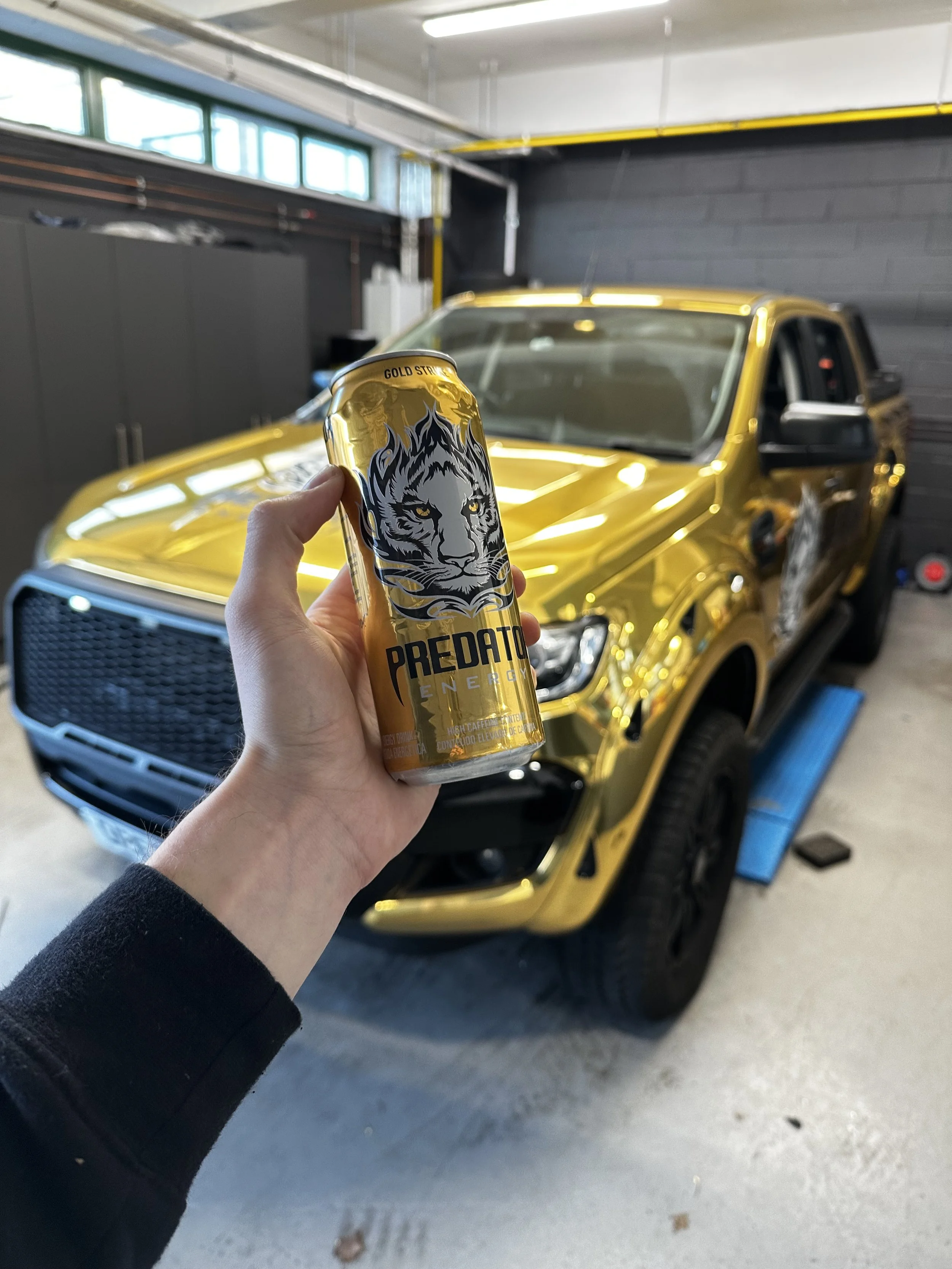 ford ranger wrapped in Avery gold chrome and branded to match the predator energy drink can.