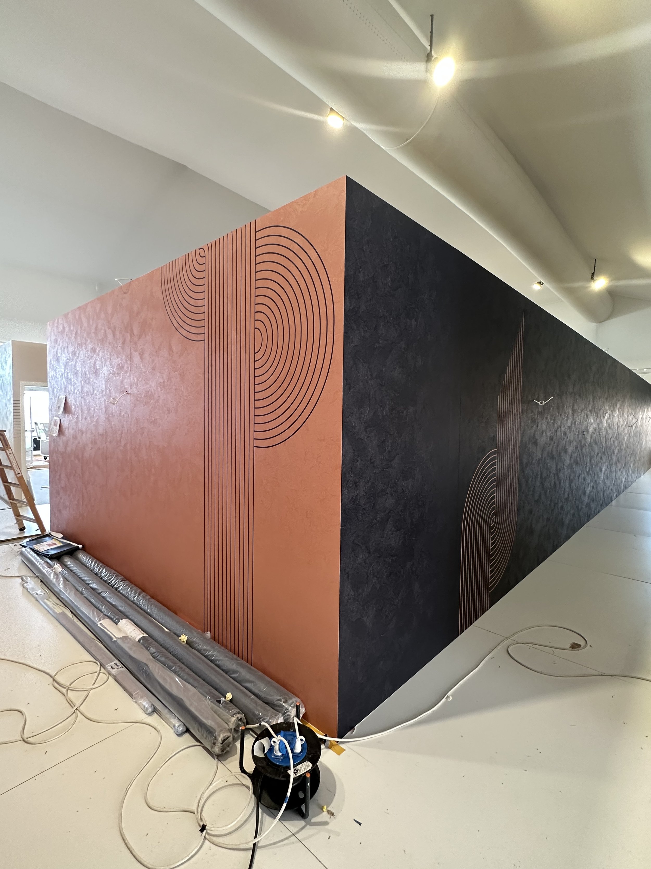 interior walls digitally vinyl wrapped in a Venetian plaster finish.