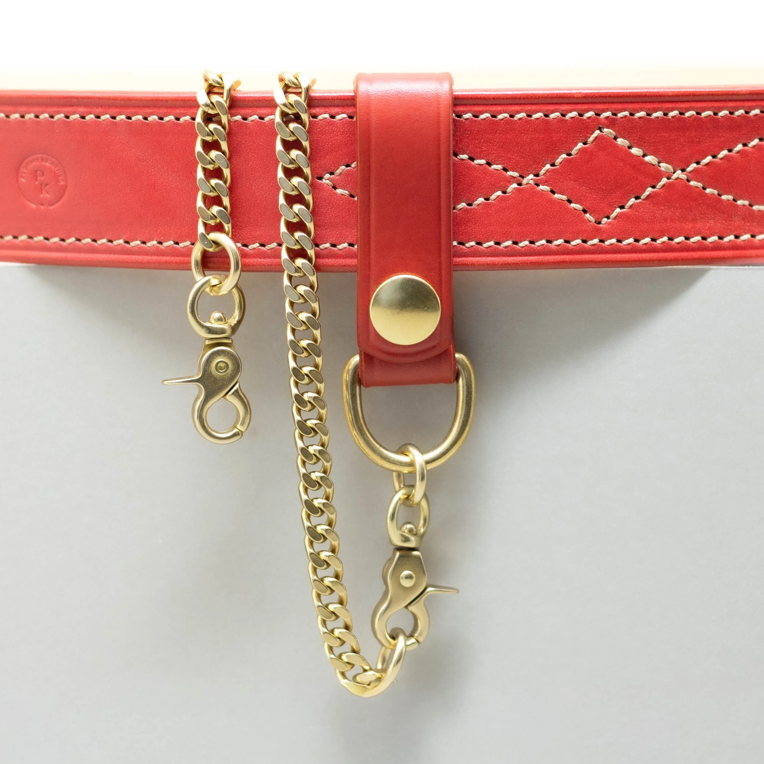 Red leather belt loop with press stud and clip with brass chain