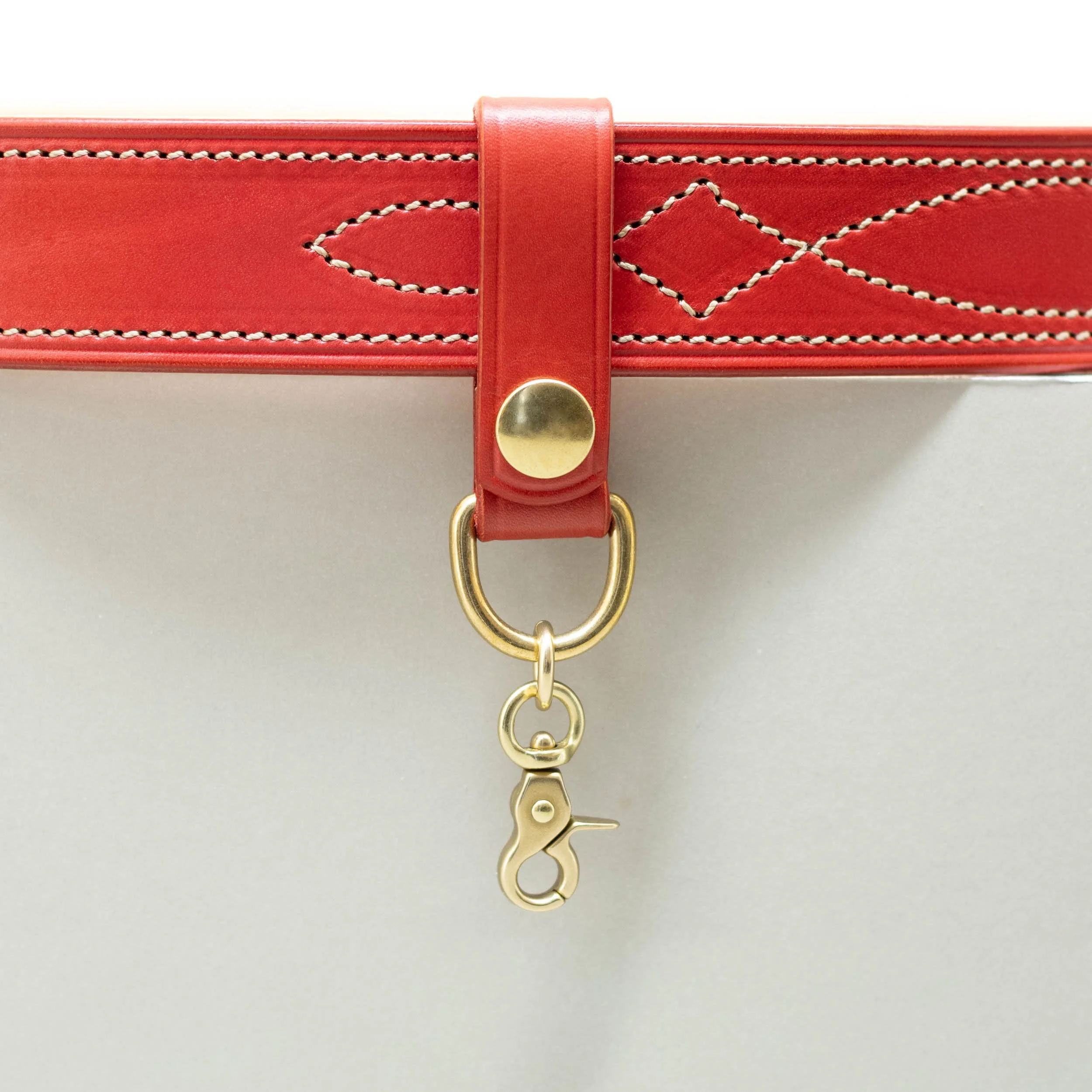 Red leather belt loop with brass press stud and clip