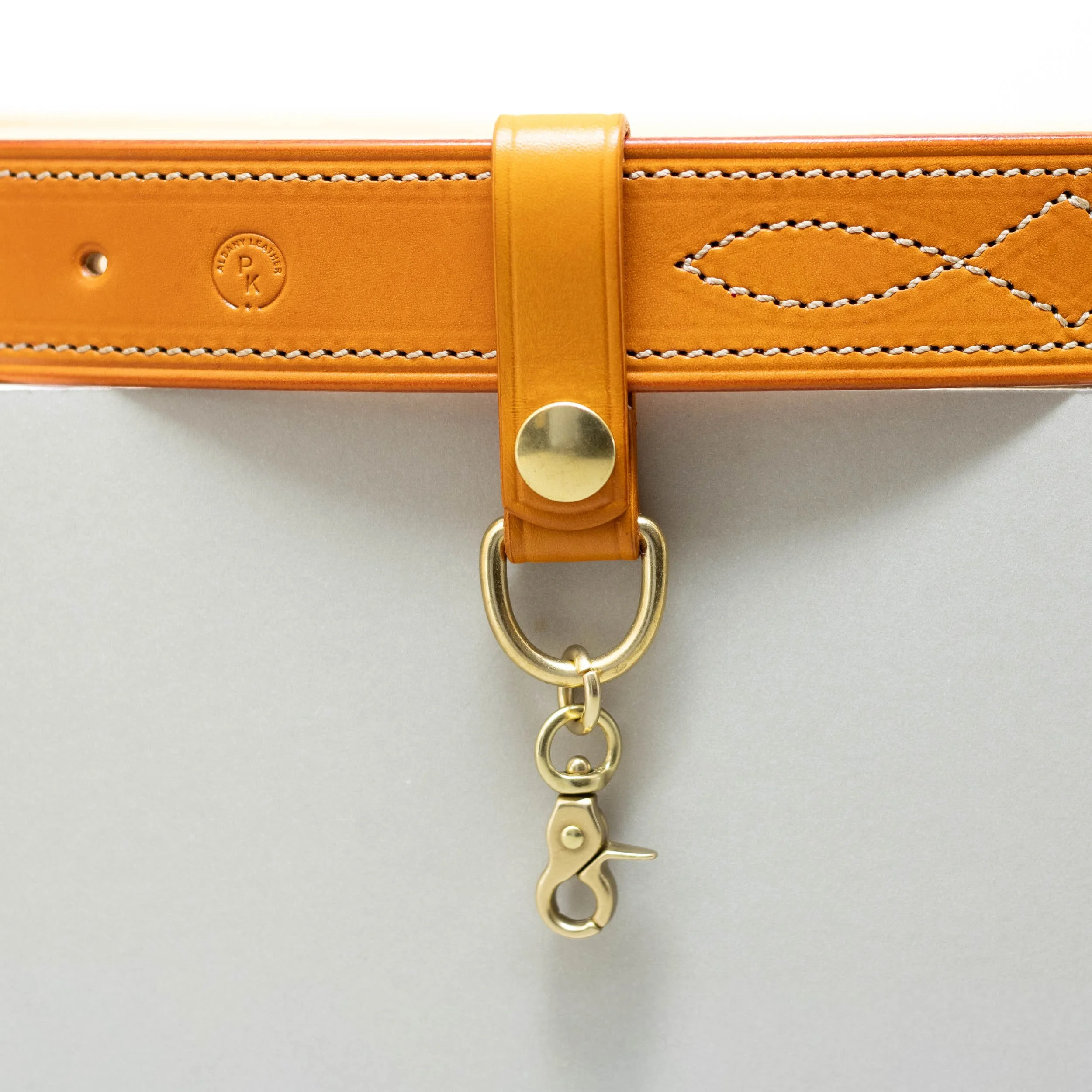 Orange leather belt loop with brass press stud and chain