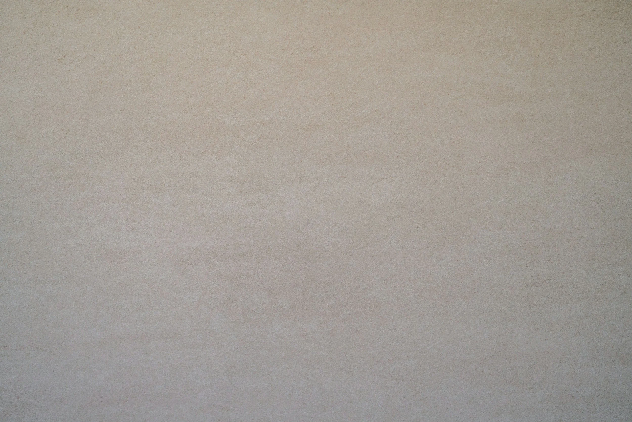 A blank, beige textured surface with no distinct objects or features.