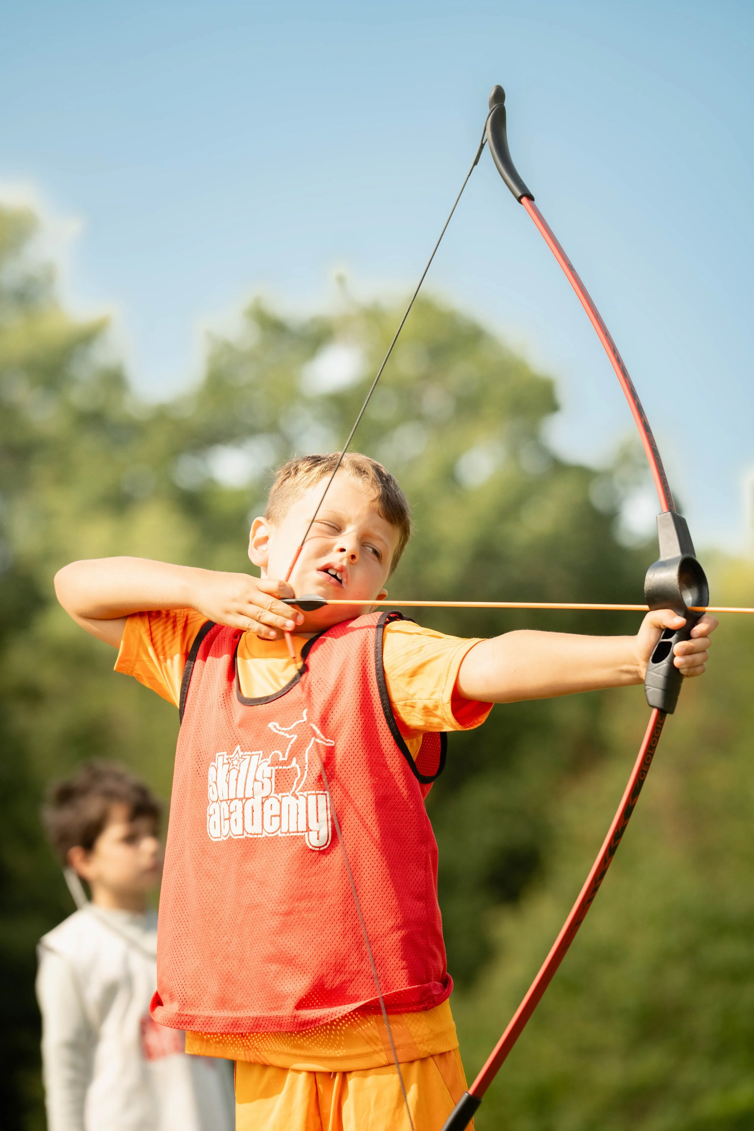 A child doing archery as part of our Orpington and Bromley multisports camps