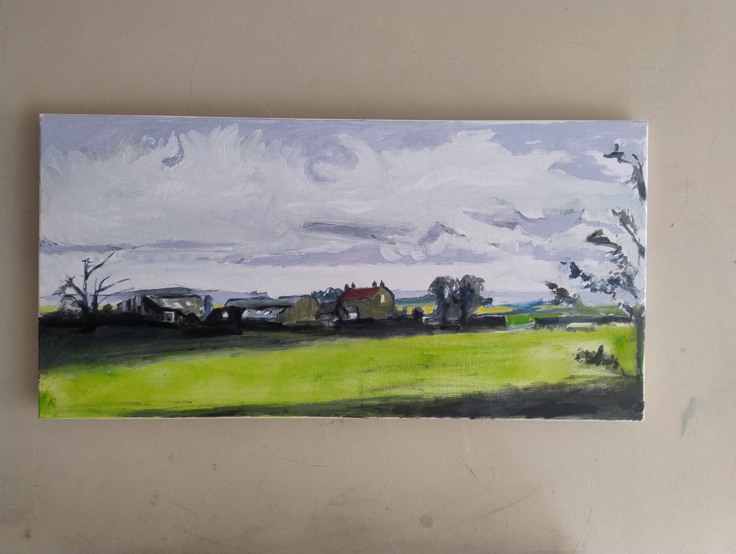 Landscape painting of a rural scene with green field, houses, trees, and a cloudy sky.