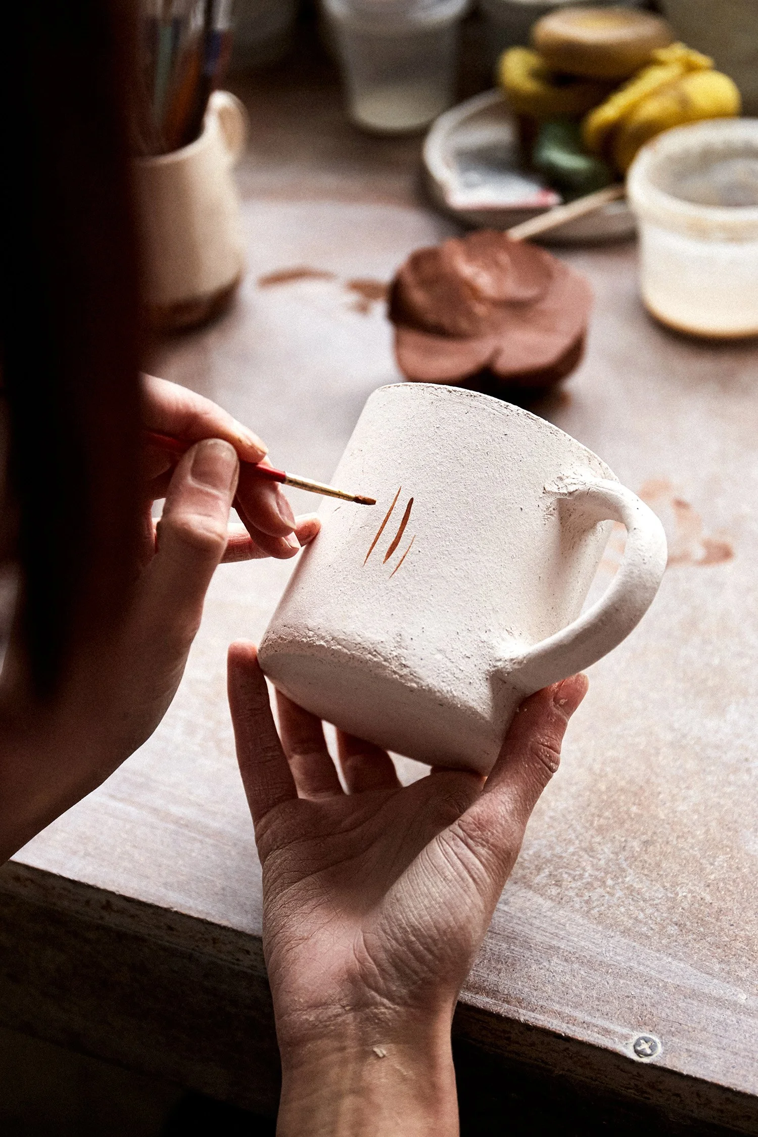 female-ceramist-working-pottery-studio-ceramists-hands-dirty-clay-process-creating-pottery-master-ceramist-works-her-studio.jpg