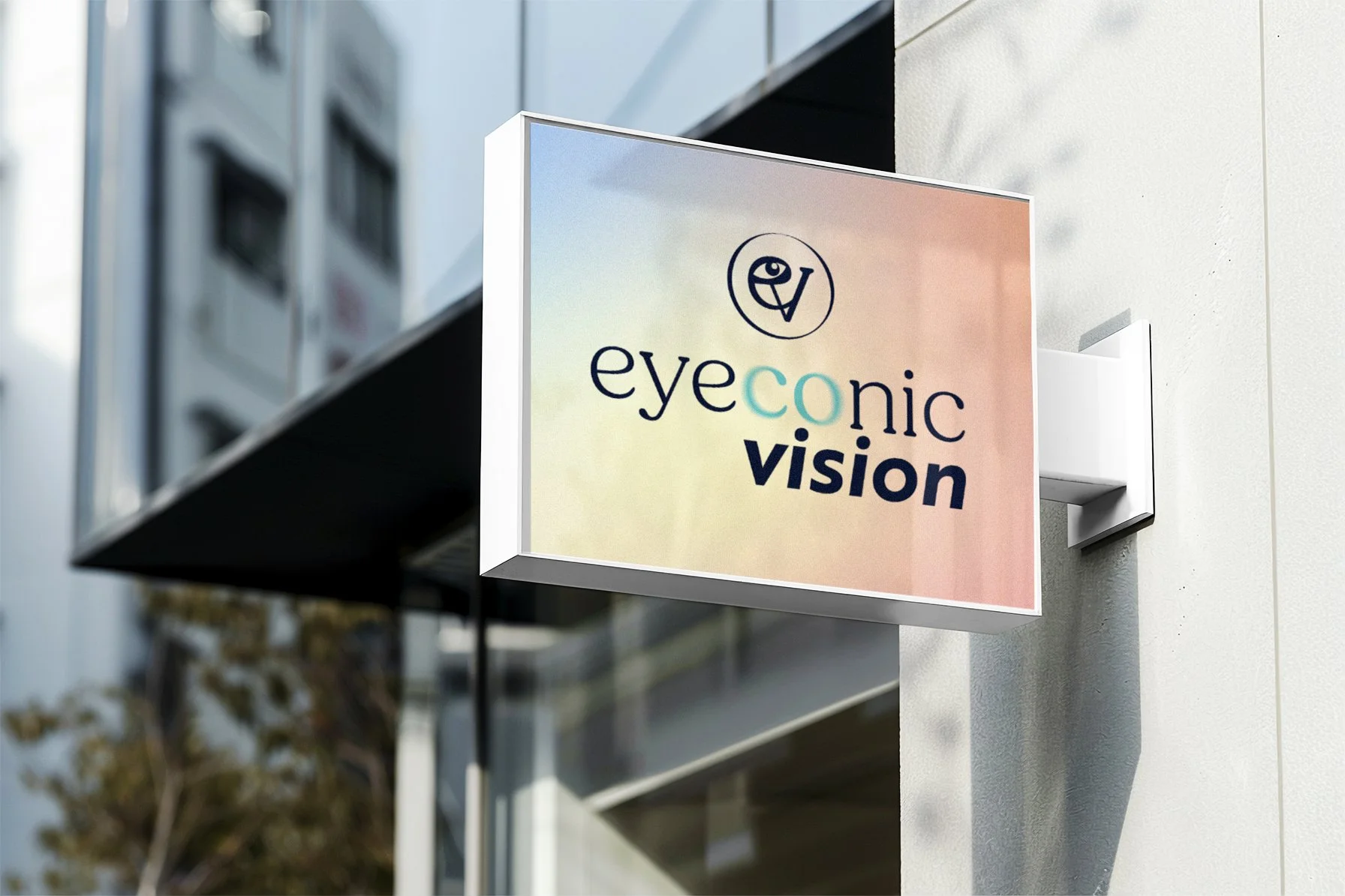 Sign for Eyeconic Vision attached to a building wall, with logo and colorful background