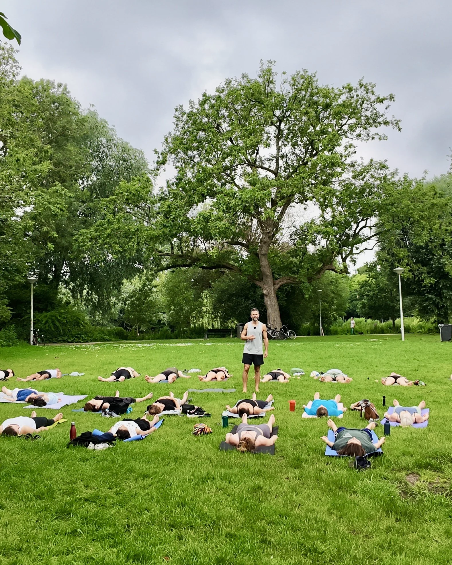 Seth Kamphuijs, eigenaar van YOGADNA, geeft yogales in Vondelpark Amsterdam