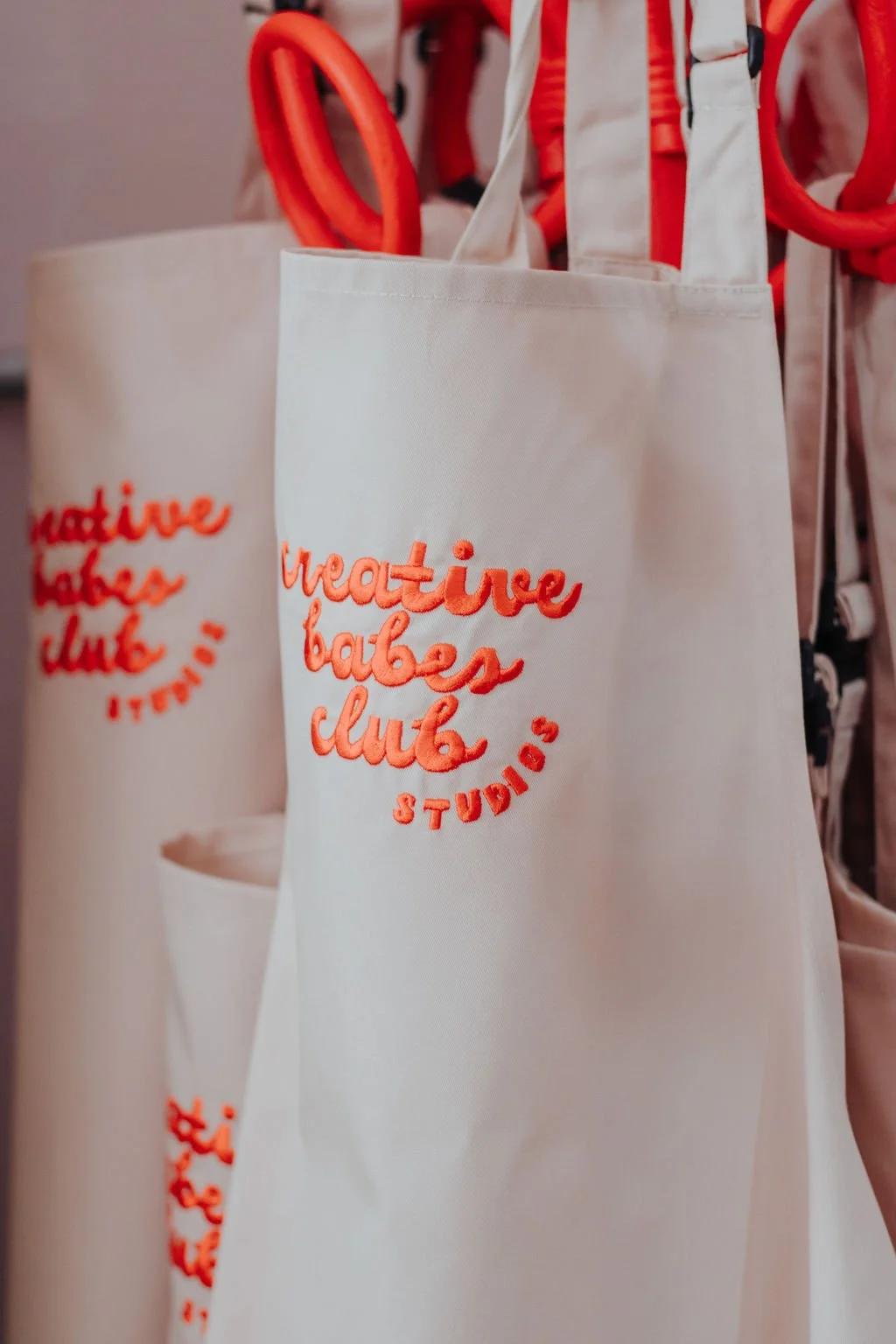 Close up of Creative Babes Club Studios' Embroidered Logo Workshop Aprons.