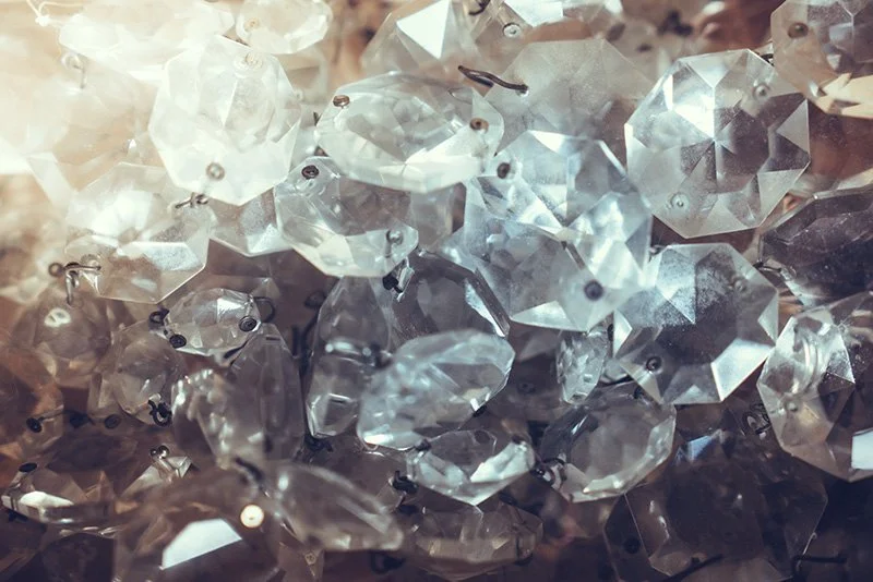 Close-up of clear and reflective faceted crystal beads or ornaments.