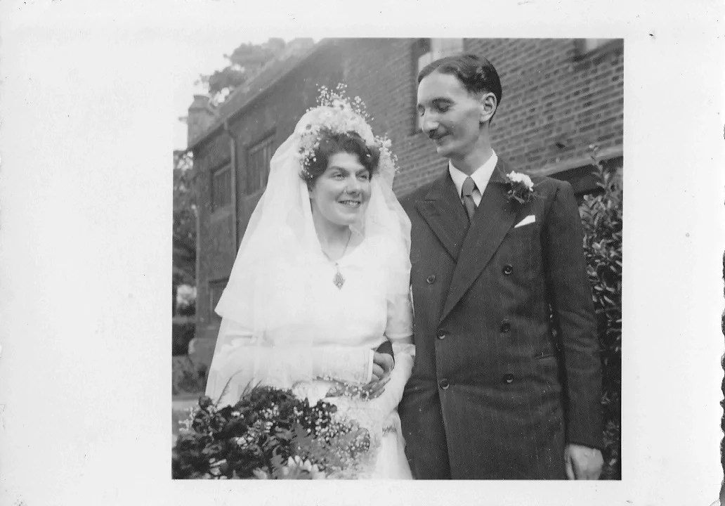 a photo in black and white of the groom looking adoringly at his new wife. wedding photo from 1951