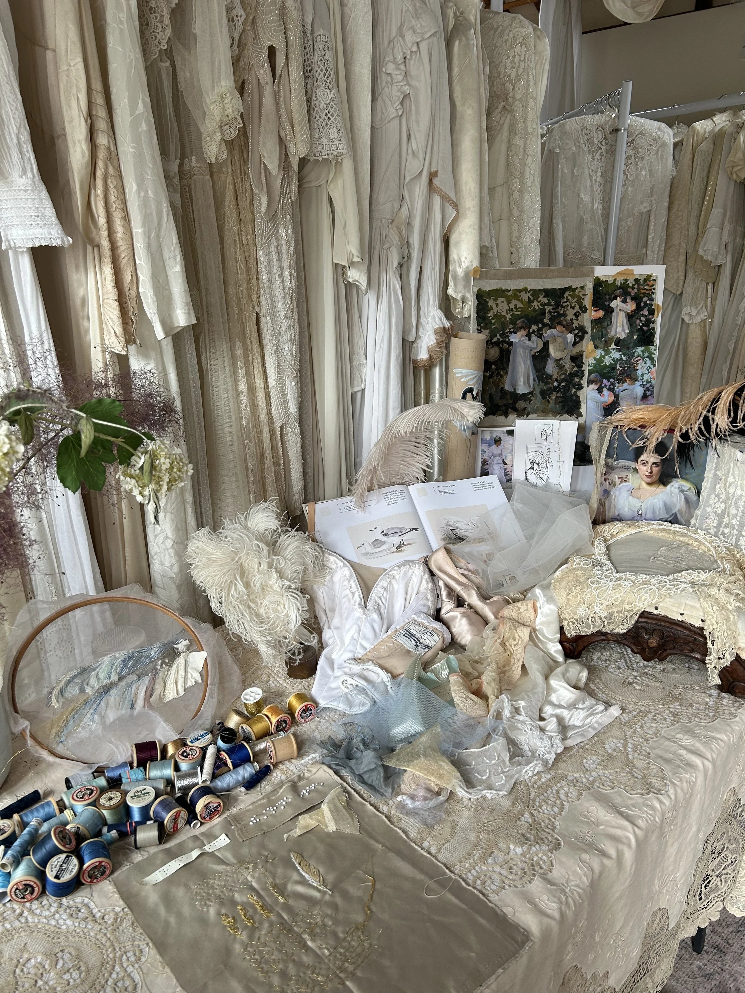 a spread of bridal textiles and various inspiring items and art