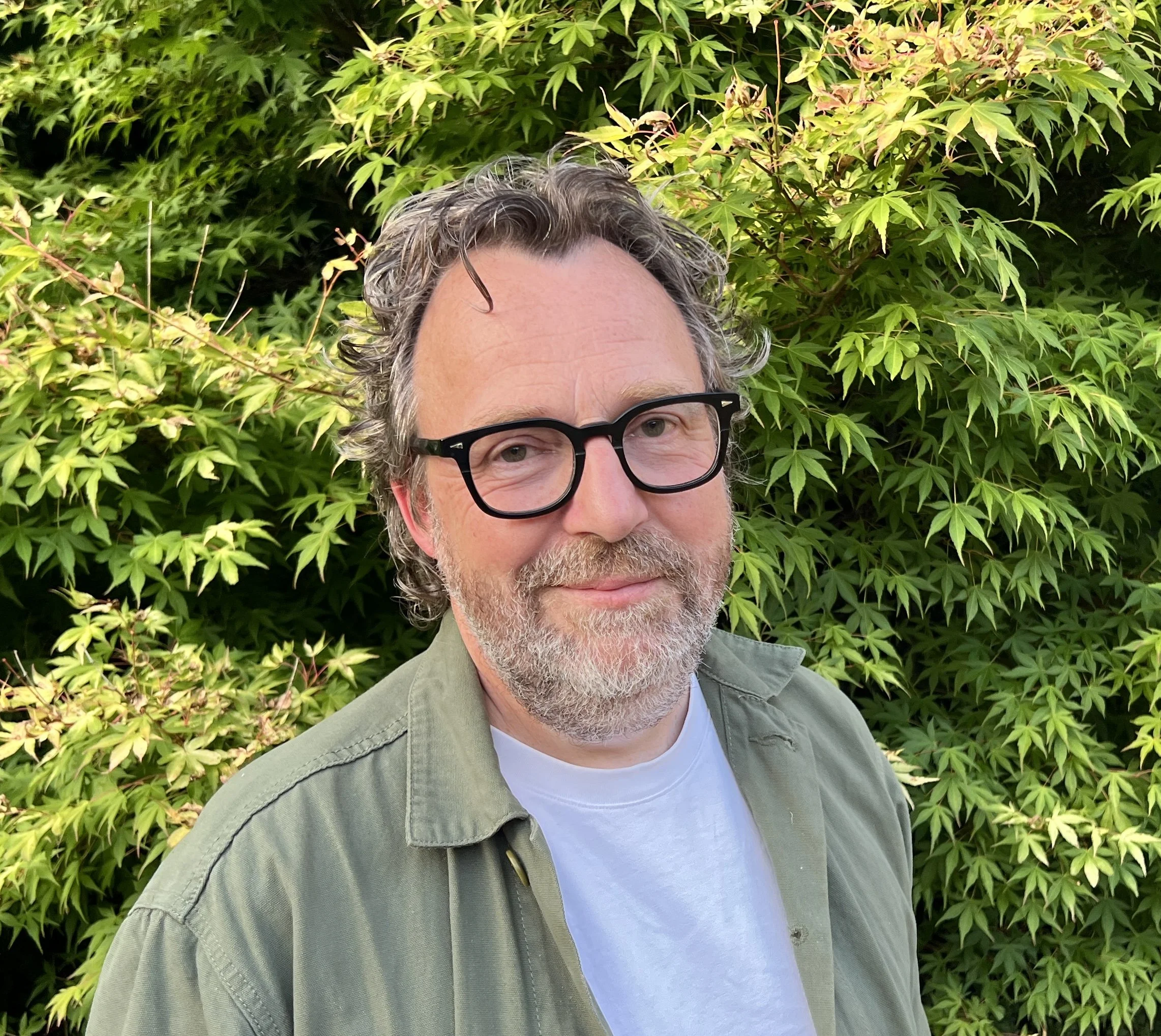 Ed Prichard, Brand Consultant, portrait standing in front of Acer tree.
