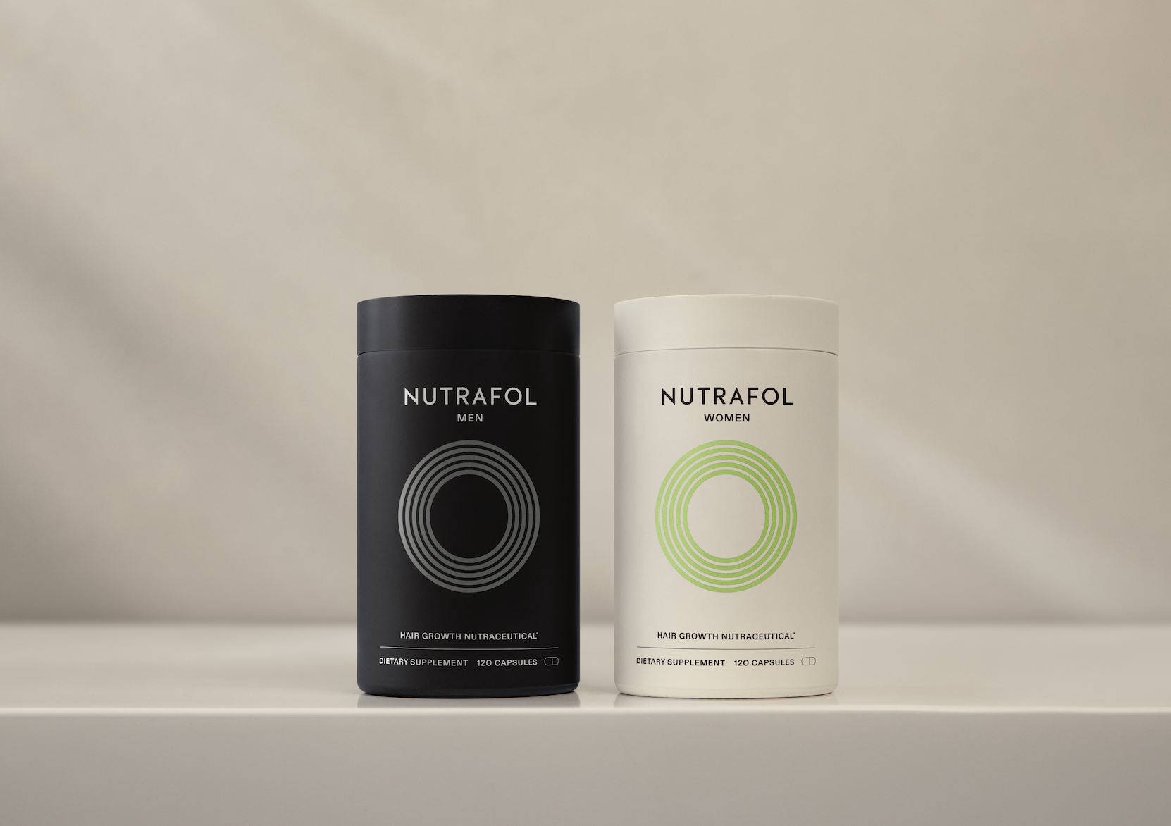 Close-up of two Nutrafol supplement bottles for hair growth, stress balance, and improved hair density