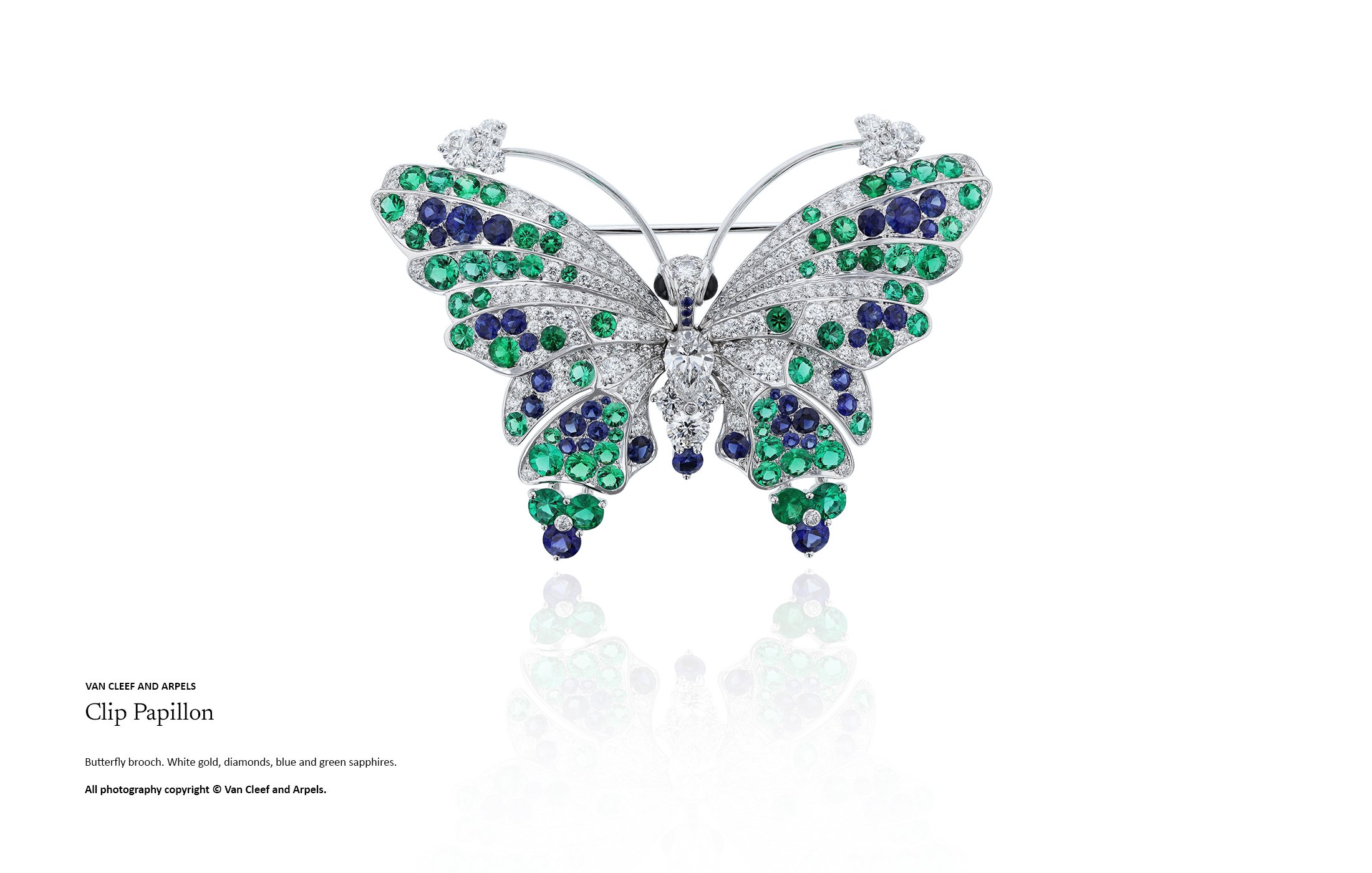 High jewellery butterfly brooch in white gold set with diamonds, green sapphires and blue sapphires, demonstrating advanced gemstone composition and symmetrical high jewellery design by Myles Day Jewellery Artist.